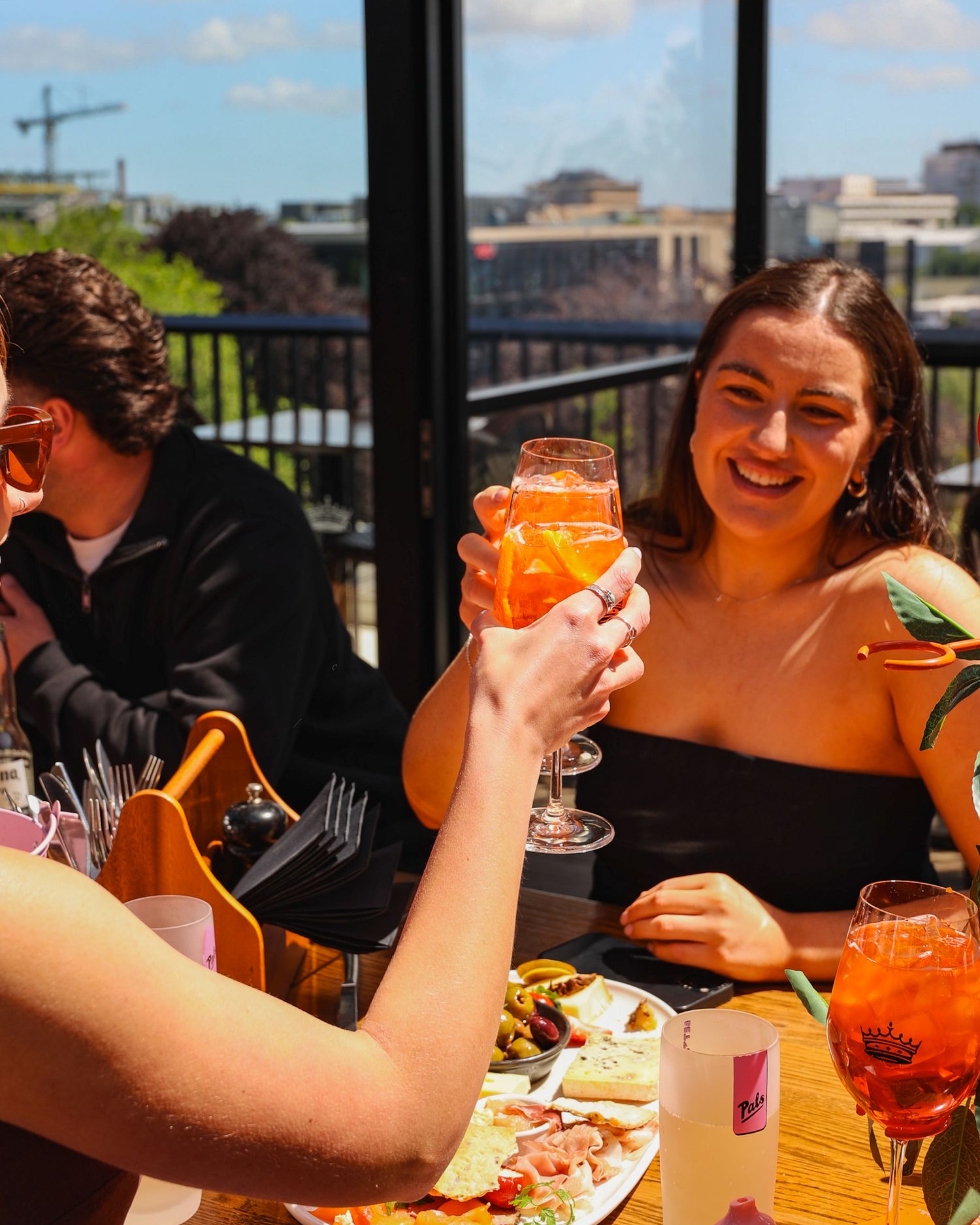 Cheersing a round of Aperol Spritz in the sunshine