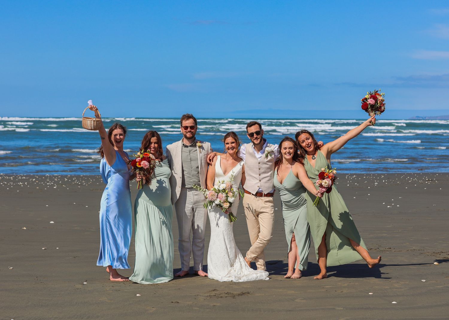 Bride, groom and bridal party posing for a group photo