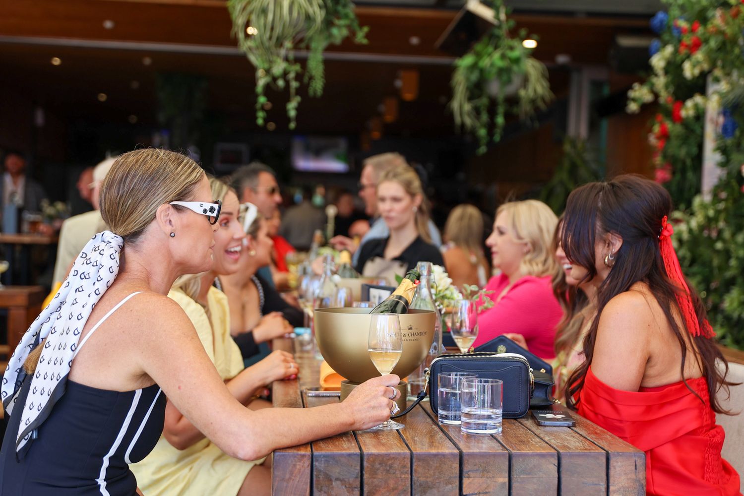 A group of ladies and a bottle of moet and Chandon champagne.