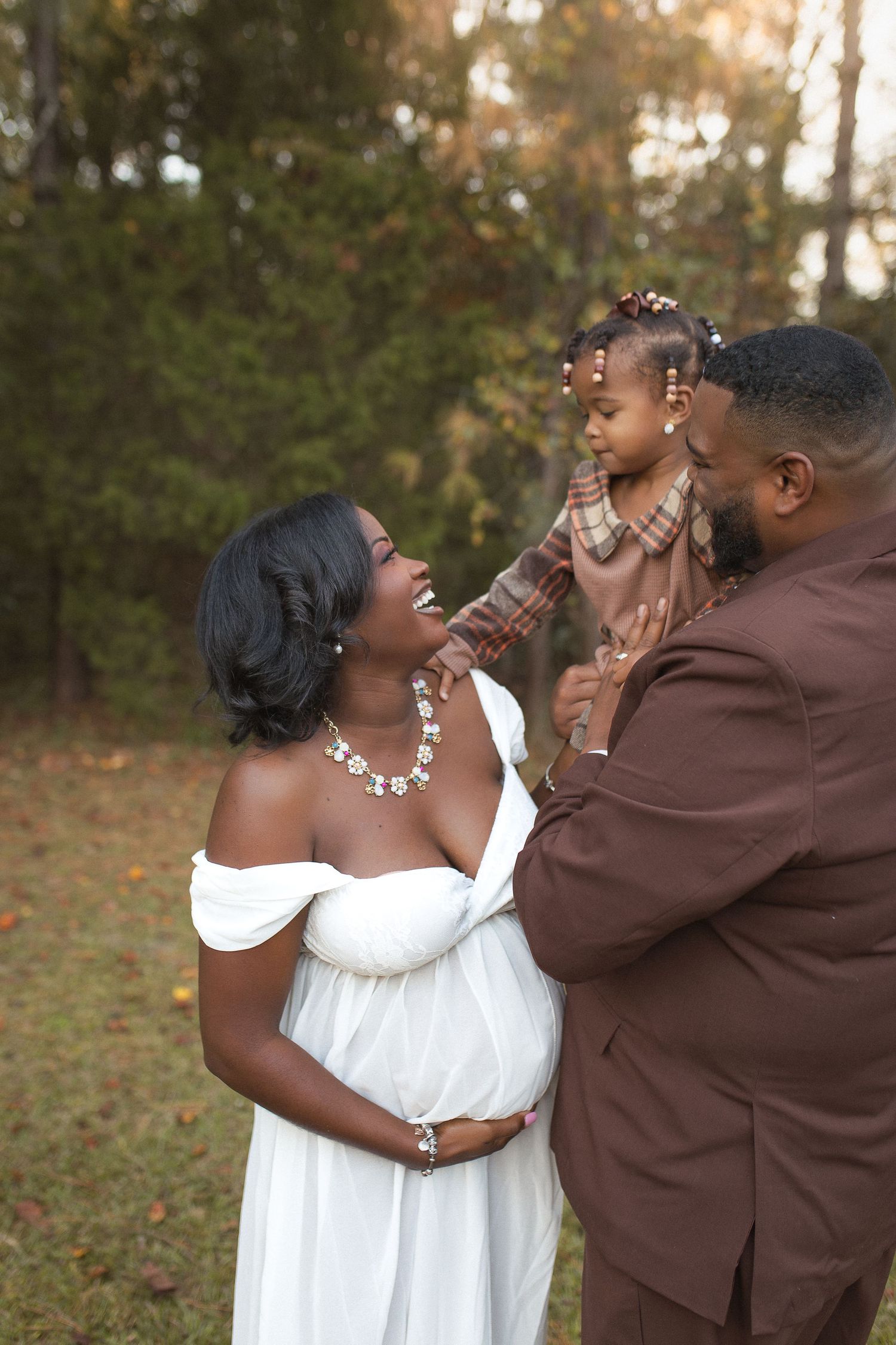 Family sharing tender moment outdoors in autumn setting.