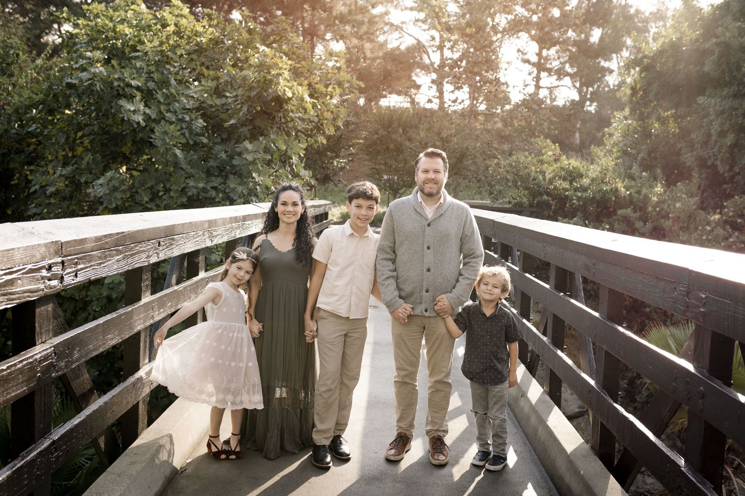 A family poses together during their outdoor photography session in Orange County, CA, surrounded by scenic natural beauty.
