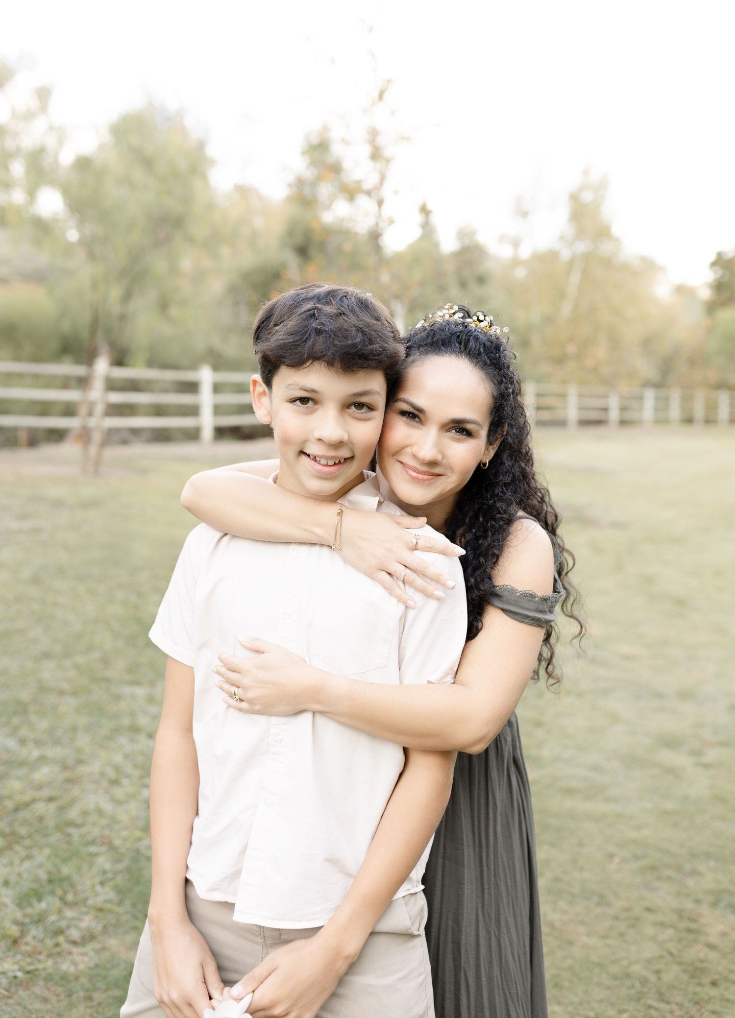 A mom and son pose together during their outdoor family session in Orange County, CA, sharing a sweet and joyful moment.