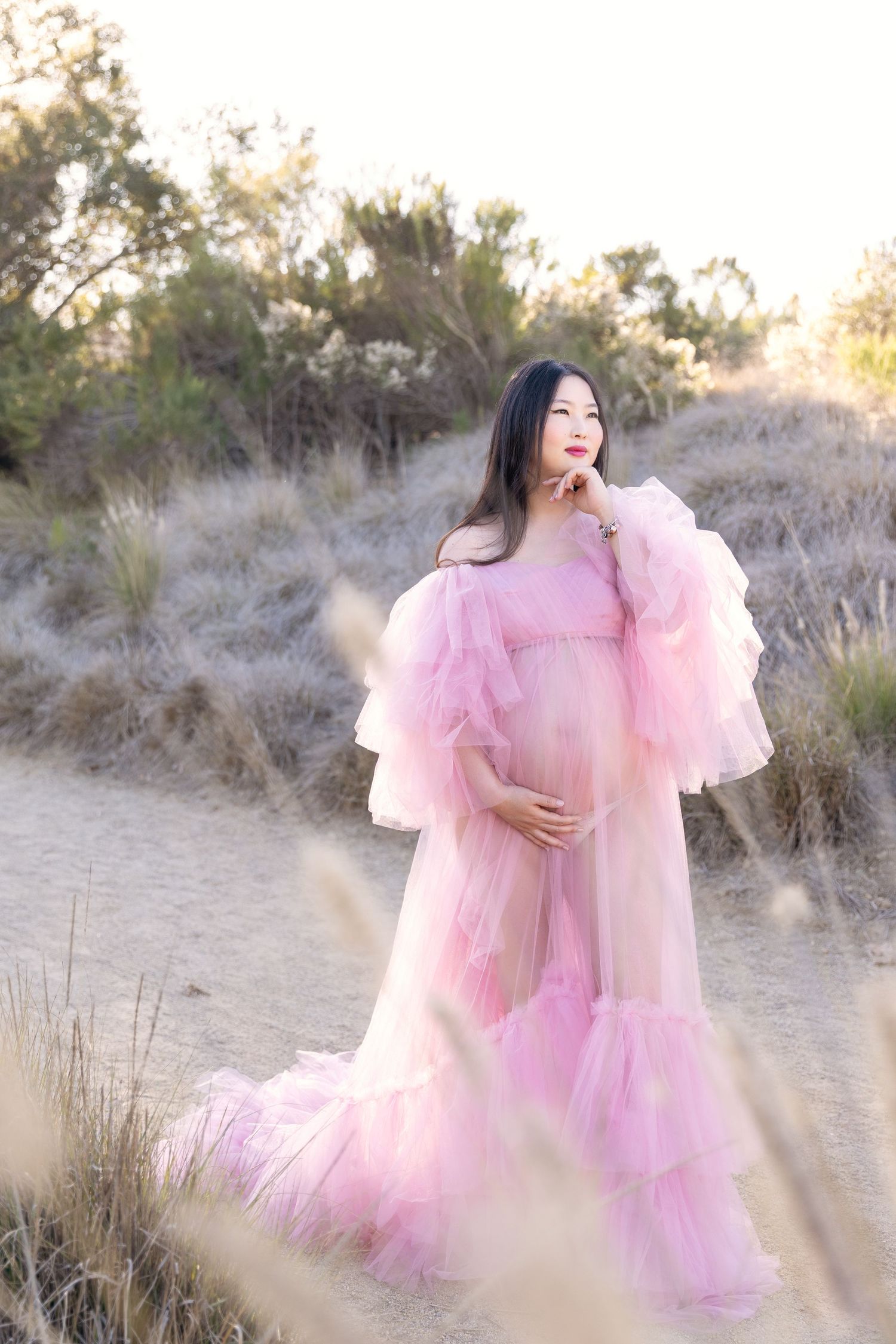 A stunning outdoor maternity photoshoot in Irvine, featuring natural scenery and soft lighting, capturing the beauty of pregnancy.