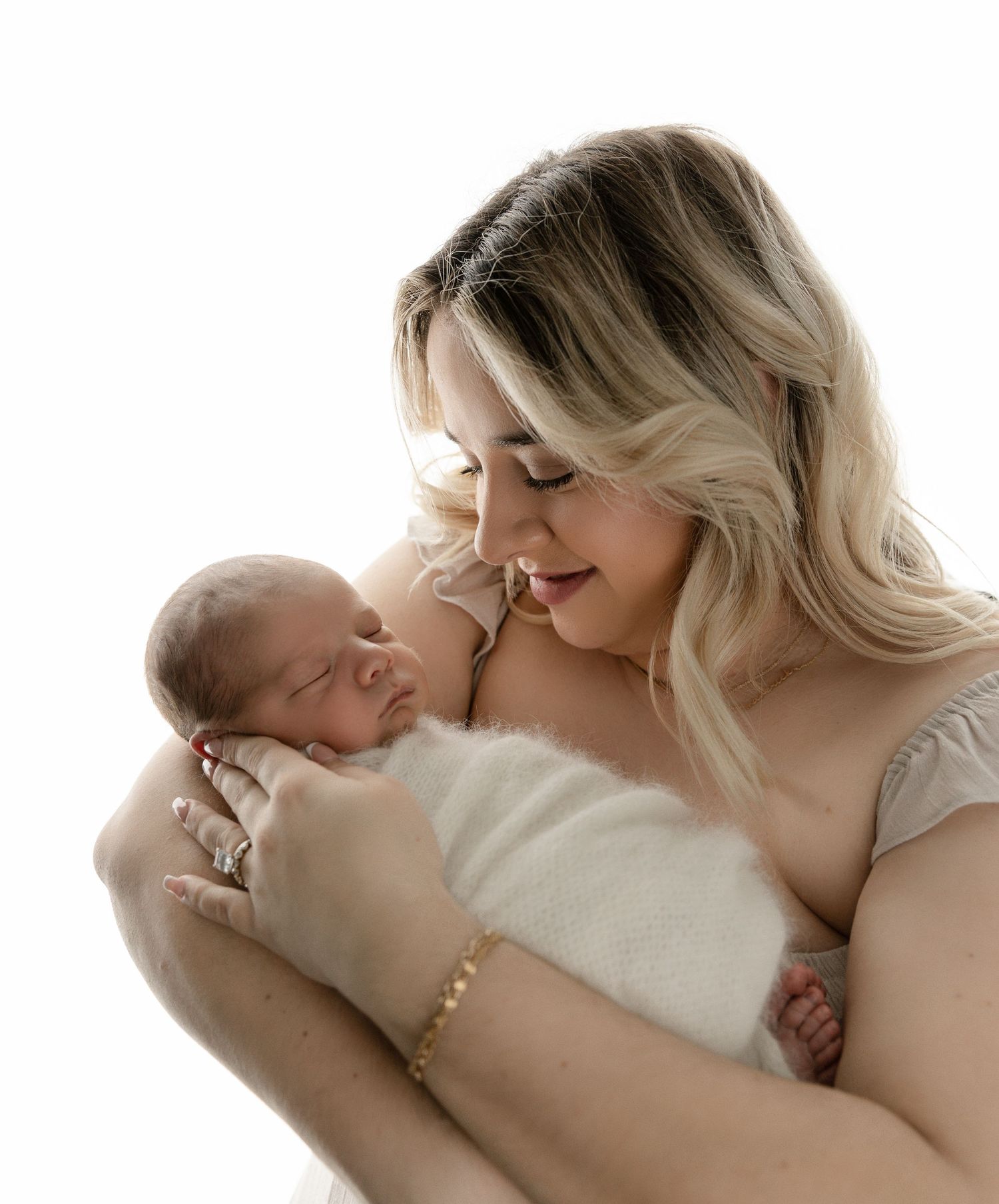 A mother gently holds her newborn baby, sharing a peaceful and tender moment together.