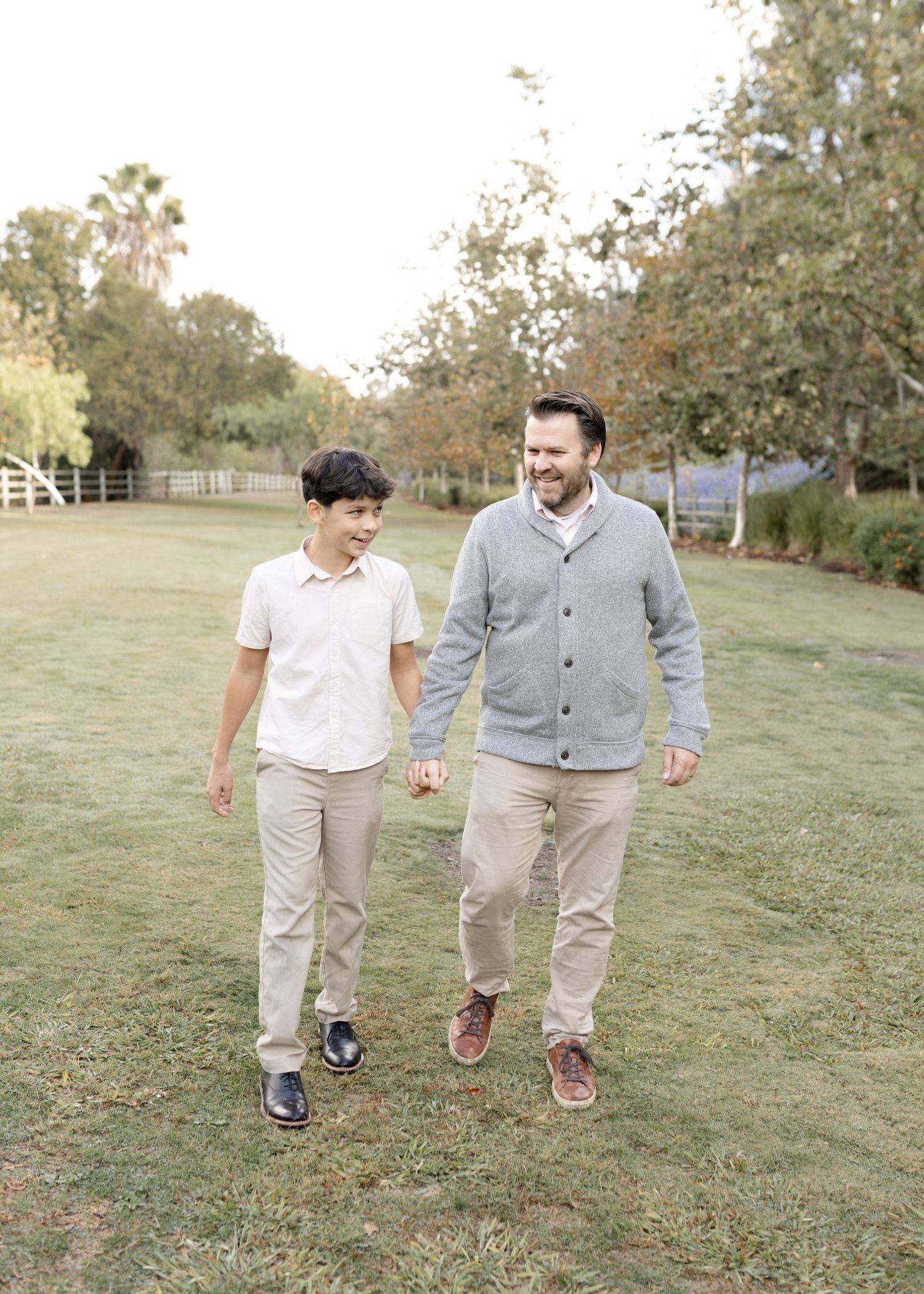 A dad shares a sweet moment with his sons during their outdoor session in Orange County, capturing a heartfelt and joyful memory.