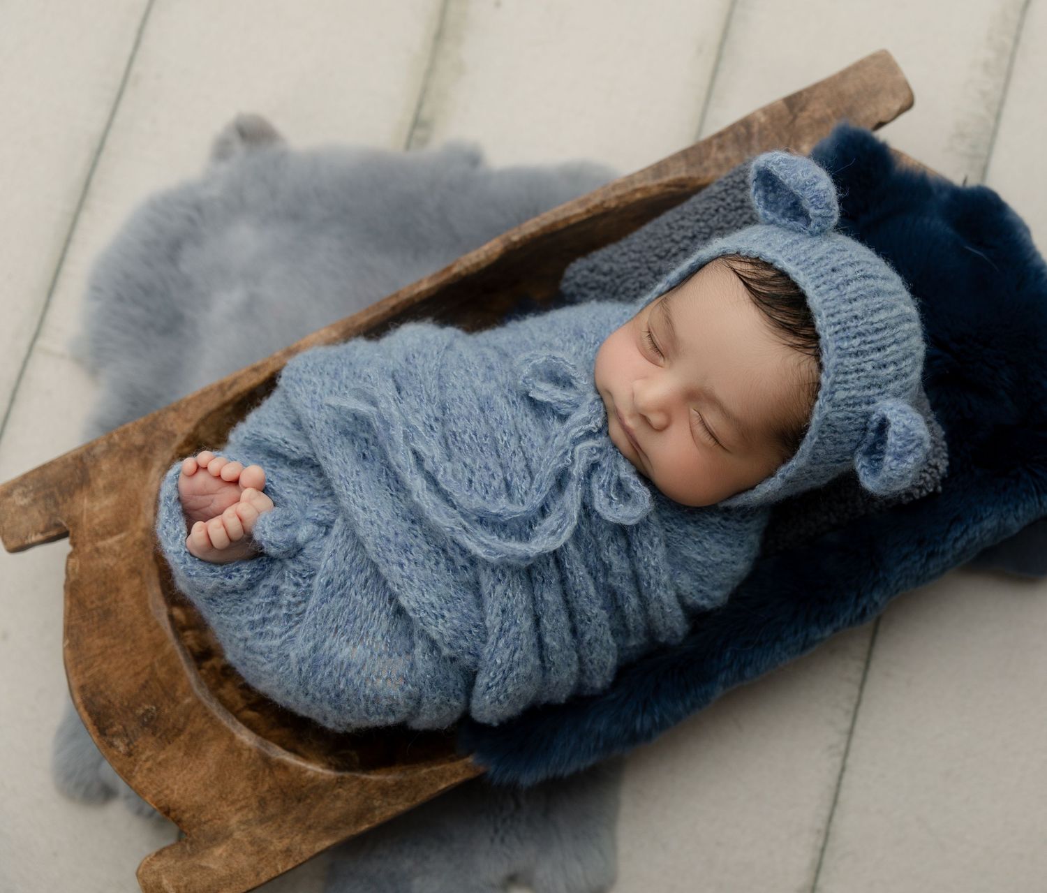 Newborn baby sleeping peacefully in a basket in Irvine CA