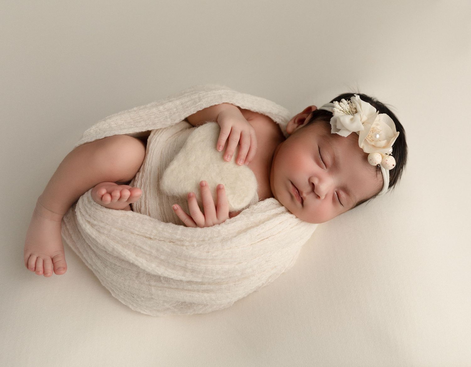 A serene in-home newborn photography session in Orange County, capturing the peaceful moments of a newborn in a cozy, intimate setting