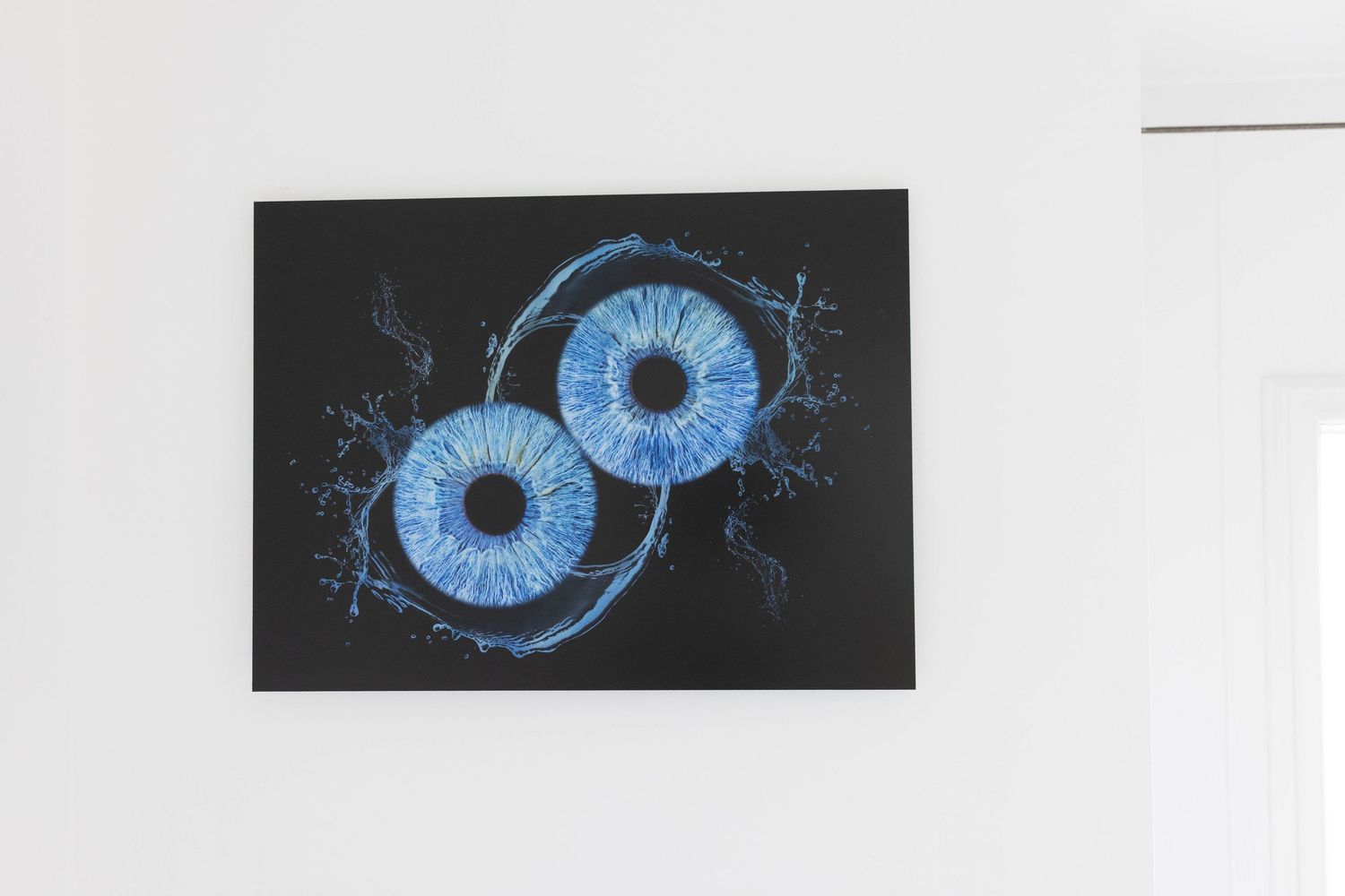 Artistic illustration of two bright blue eyeballs with electric lightning effects against a black background.