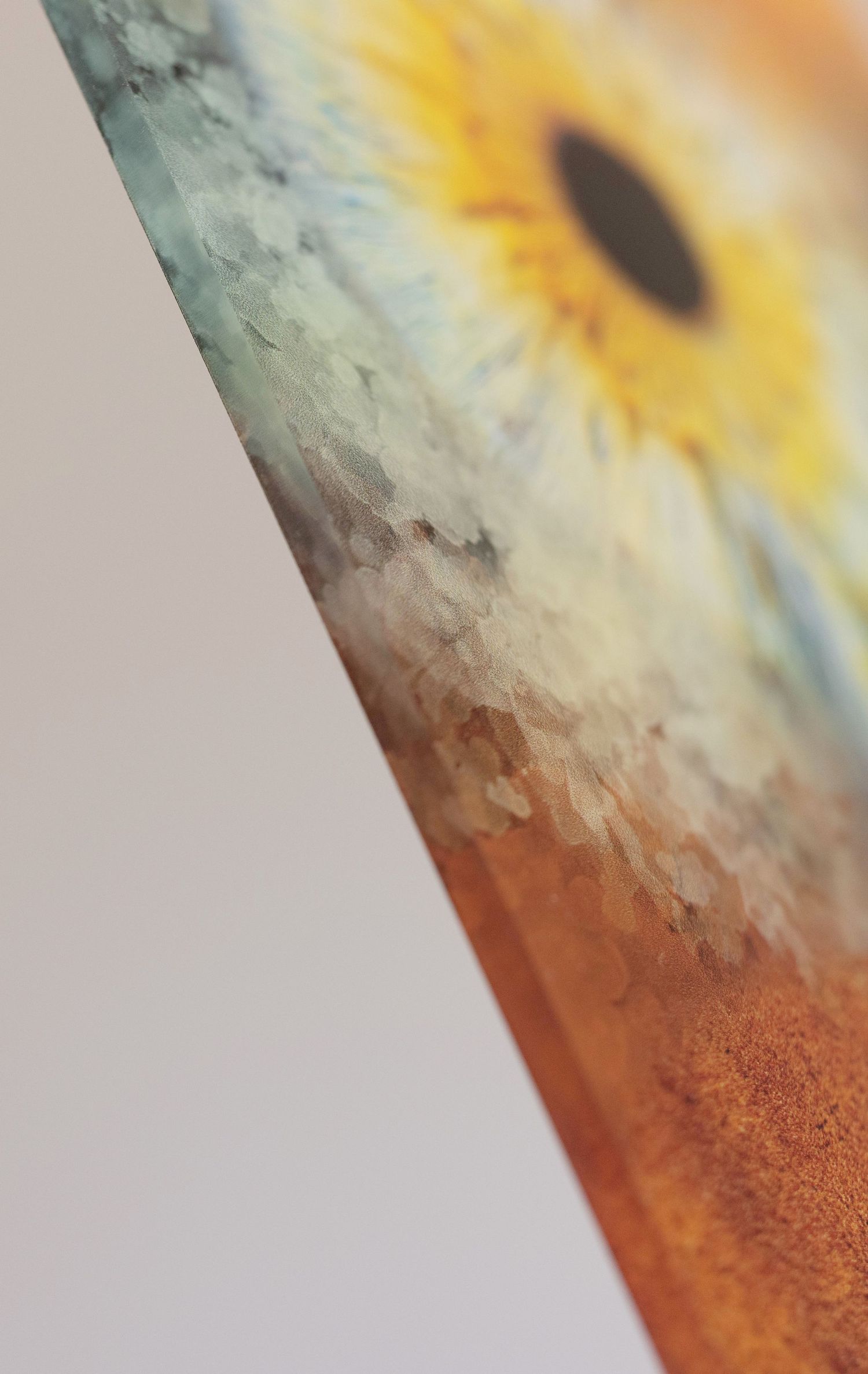 A close-up artistic macro photo shows the corner of a rusty metal surface with a blurred yellow sunflower in the background.