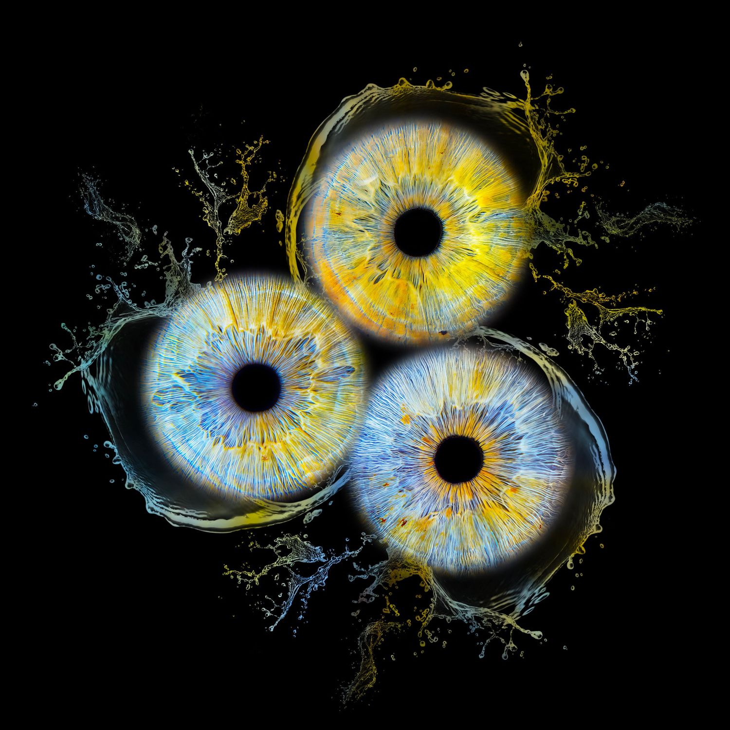 Three human eyes with blue and yellow irises arranged in a circular pattern with liquid splashes on black background.