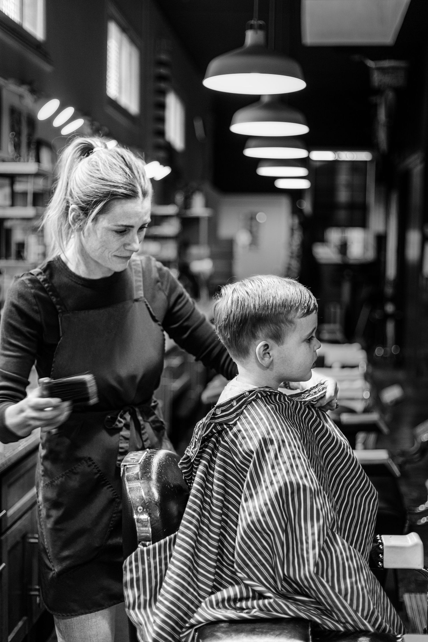 Fine art storytelling portrait of a Montrose Barbershop in La Crescenta, where the owner is passionately giving a haircut for a client