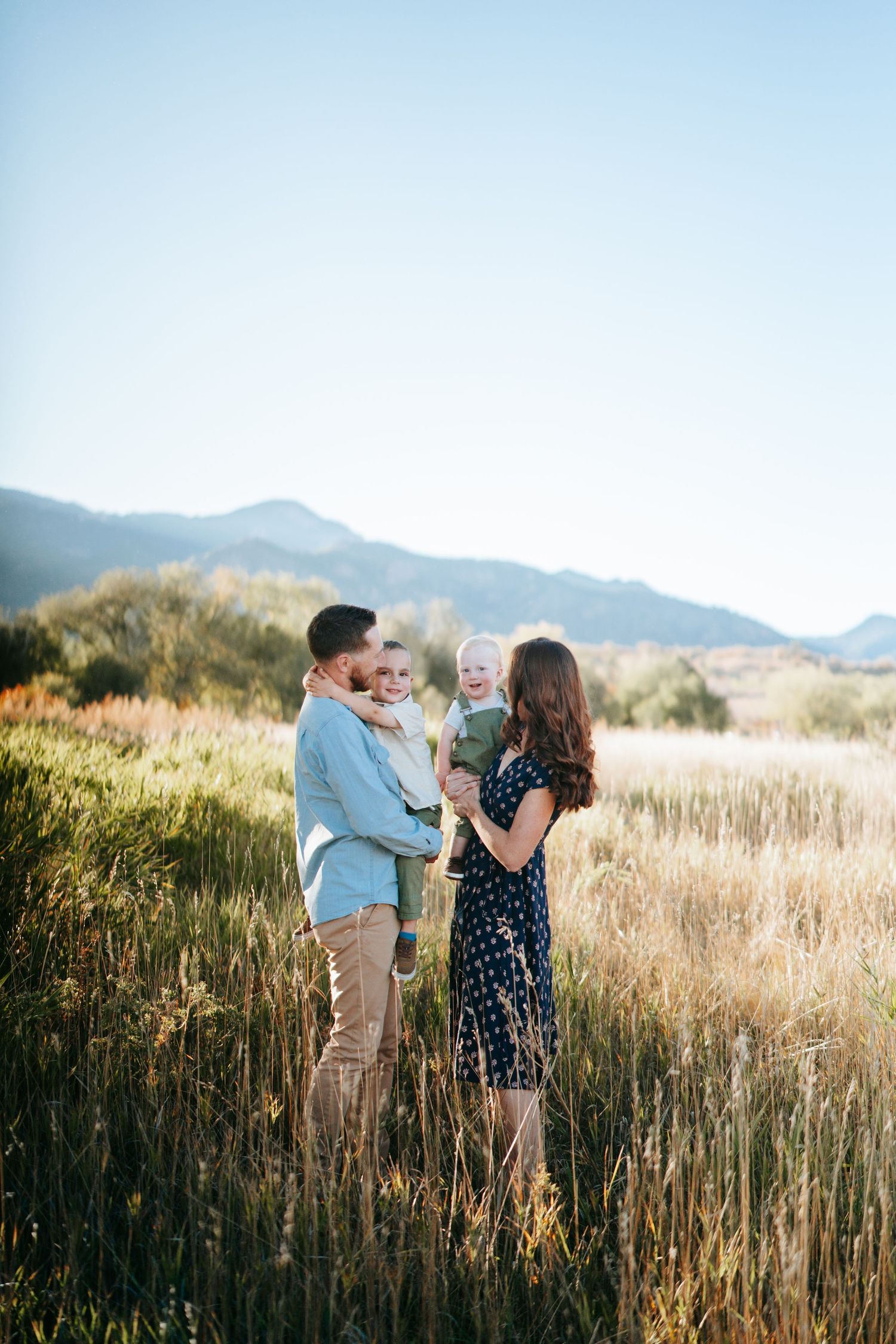 Colorado Springs family photo session in a beautiful field with unique mountain views.