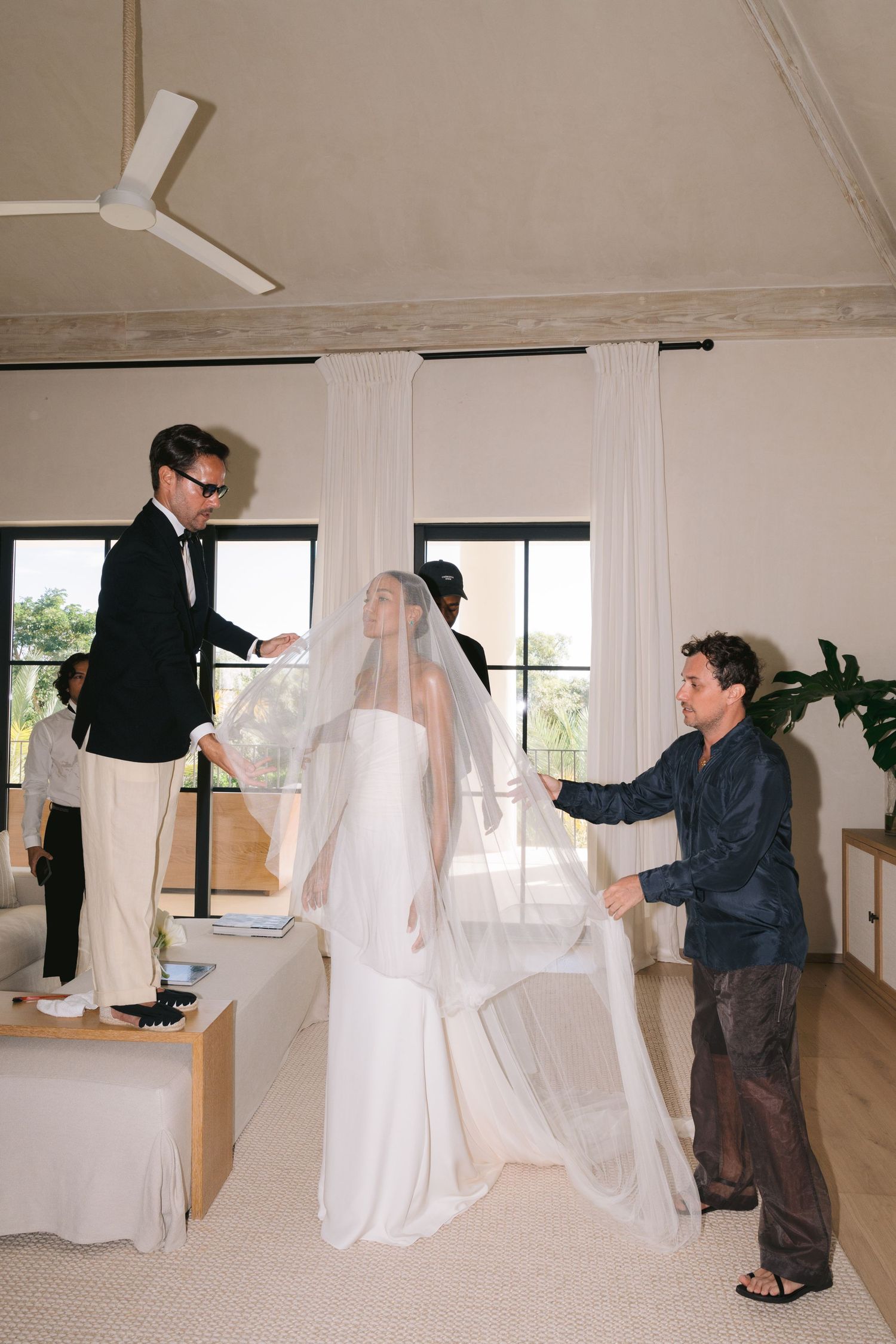 Sequential photos show a photographer setting up lighting and camera equipment in a bright studio space.