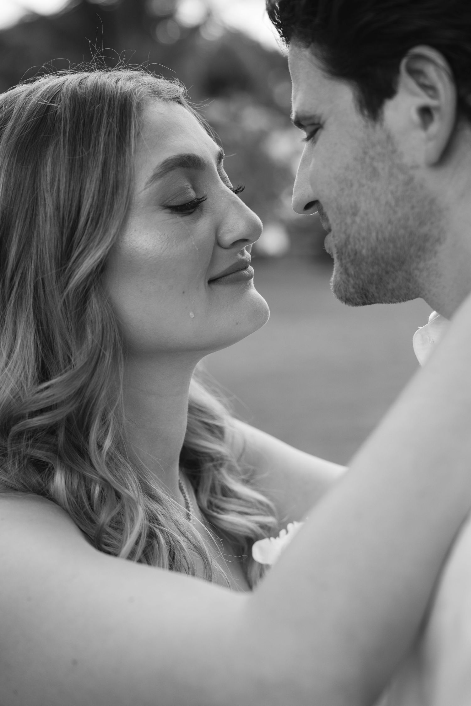 A romantic black and white photo series showing tender moments between a couple in an intimate embrace.