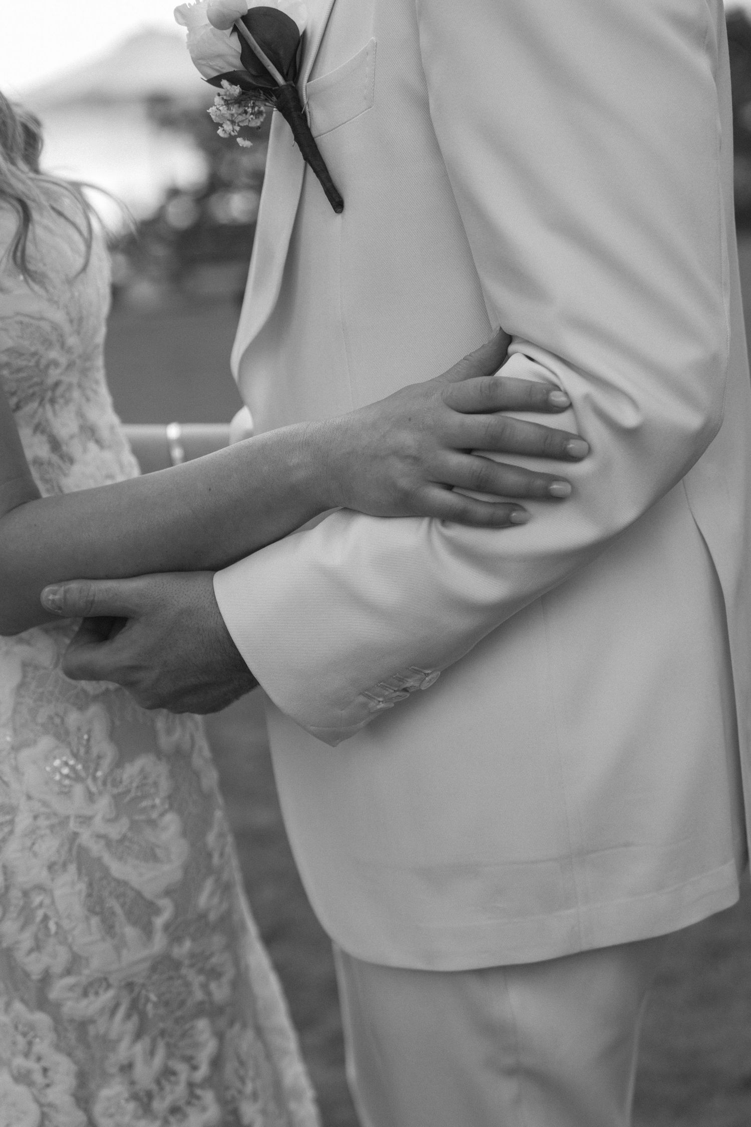 A series of black and white close-up photos showing hands gently cradling a pregnant belly.