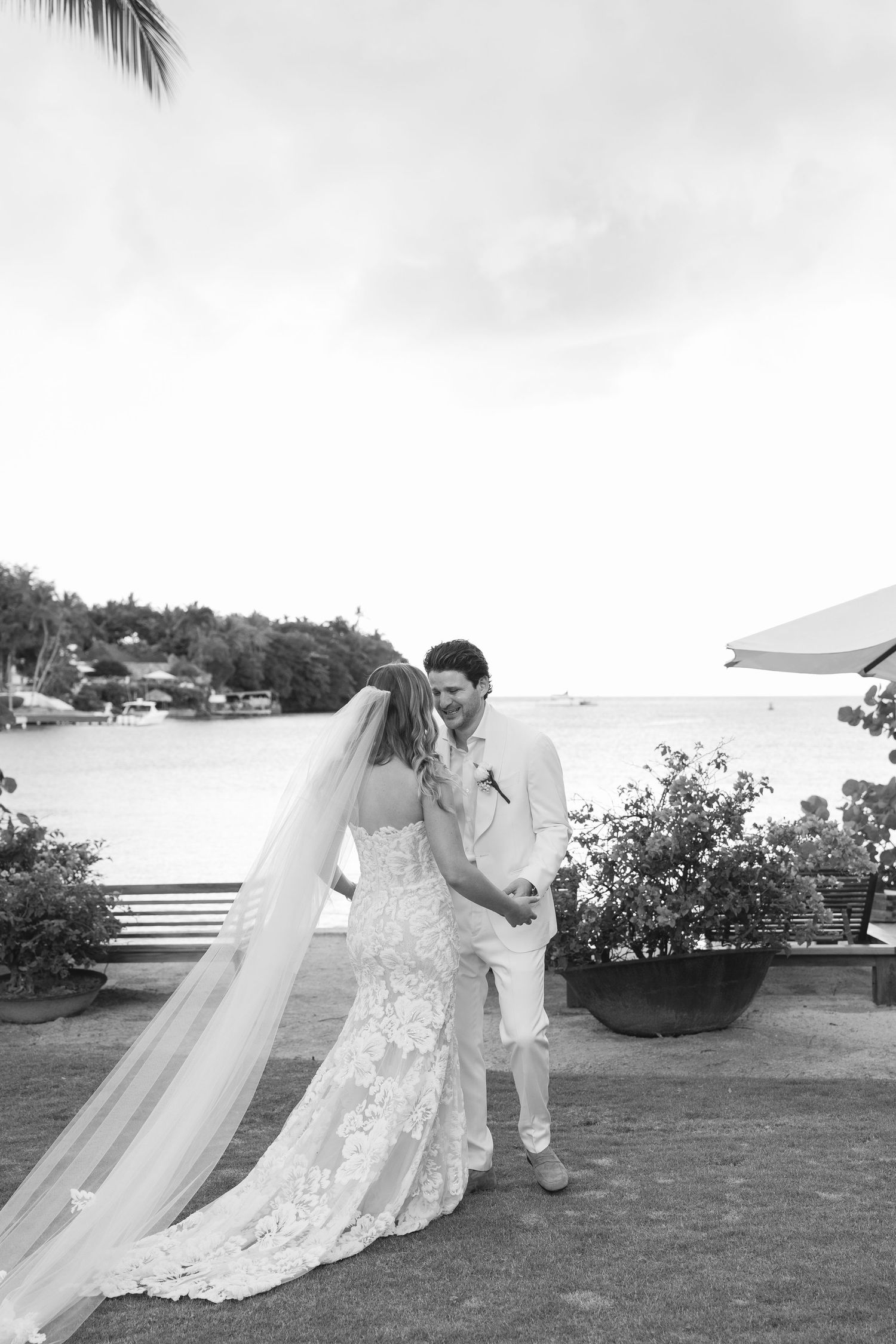 A romantic black and white wedding photoshoot sequence showing a couple dancing on a scenic oceanfront lawn.