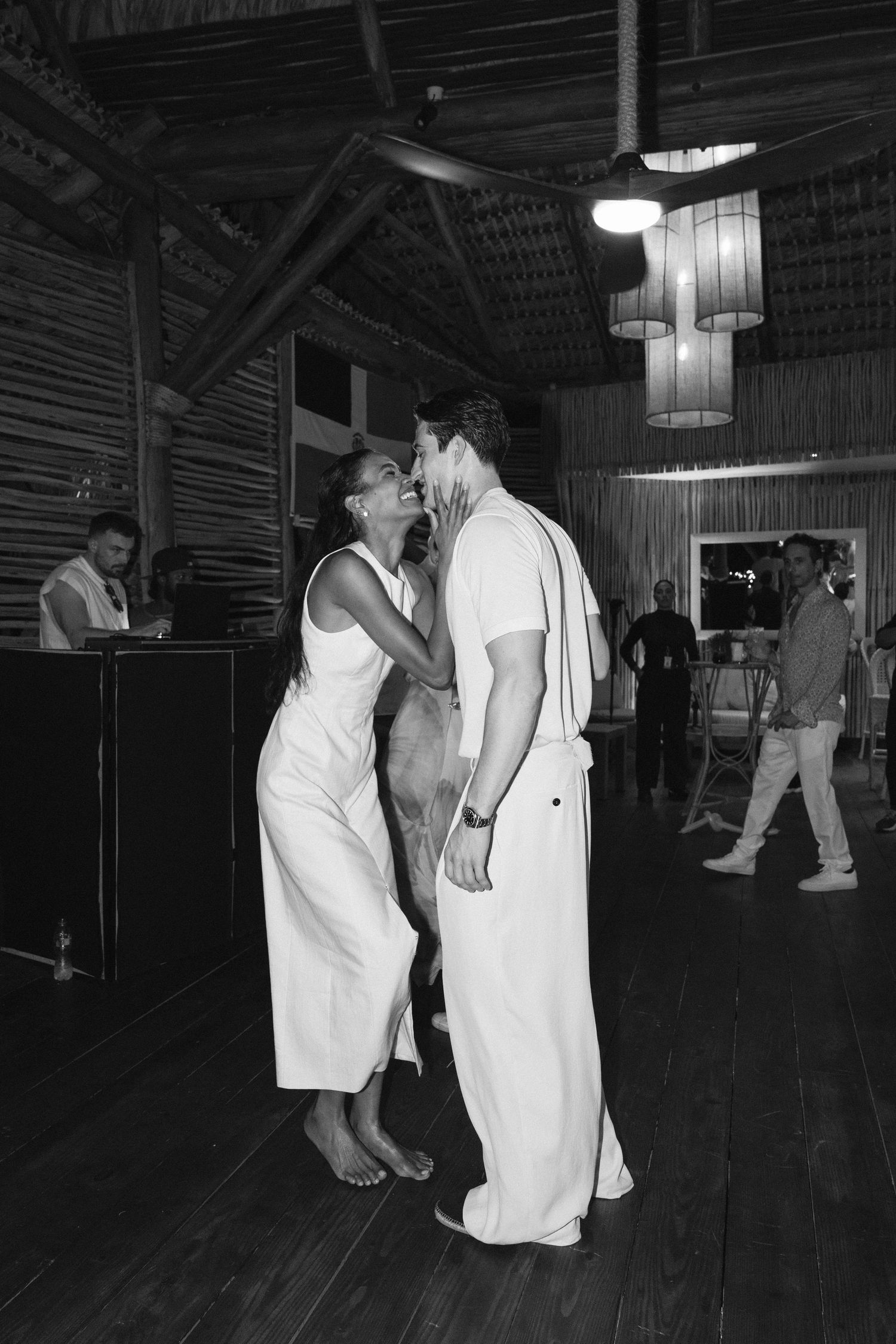 Black and white photo of a couple dancing in an intimate slow dance at what appears to be a dance hall or social club.