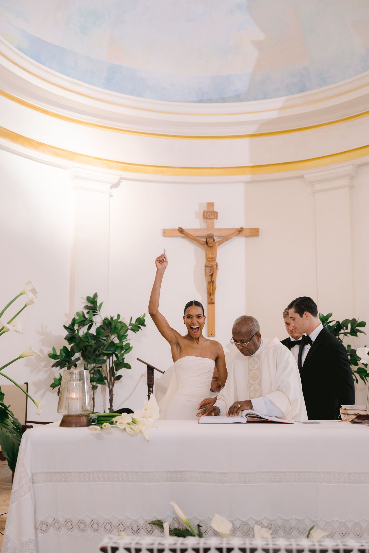 Four sequential photos of a church altar during a Catholic wedding ceremony with a white domed ceiling and religious decor.