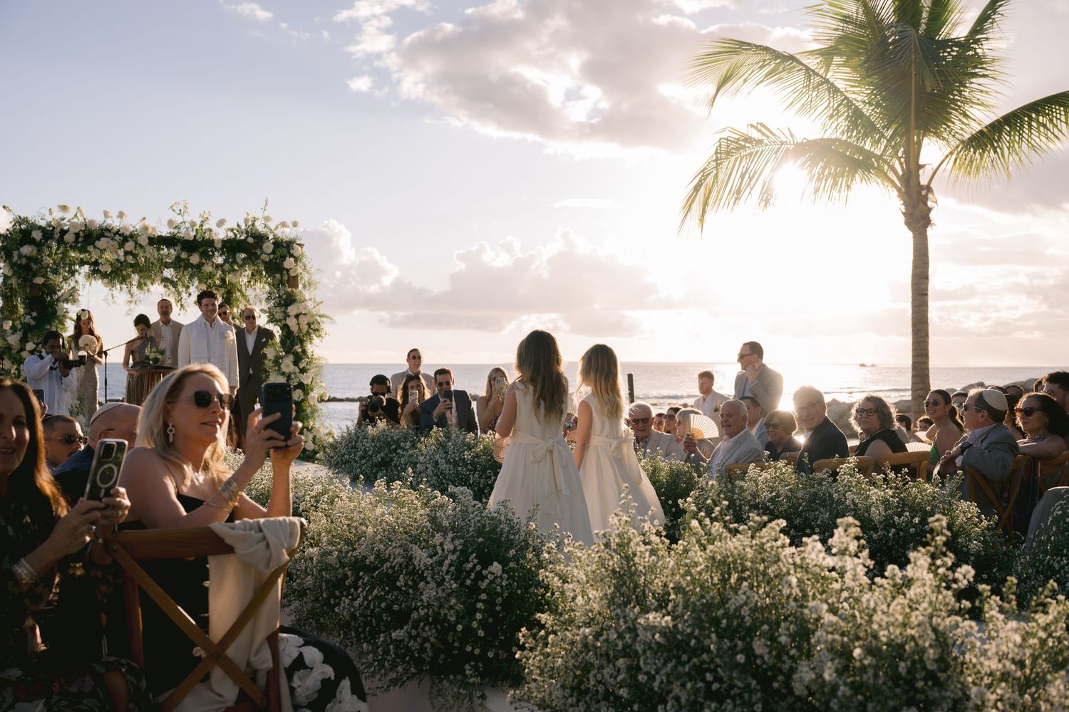 Panoramic sequence of a tropical beach wedding ceremony at sunset with palm trees and ocean views.