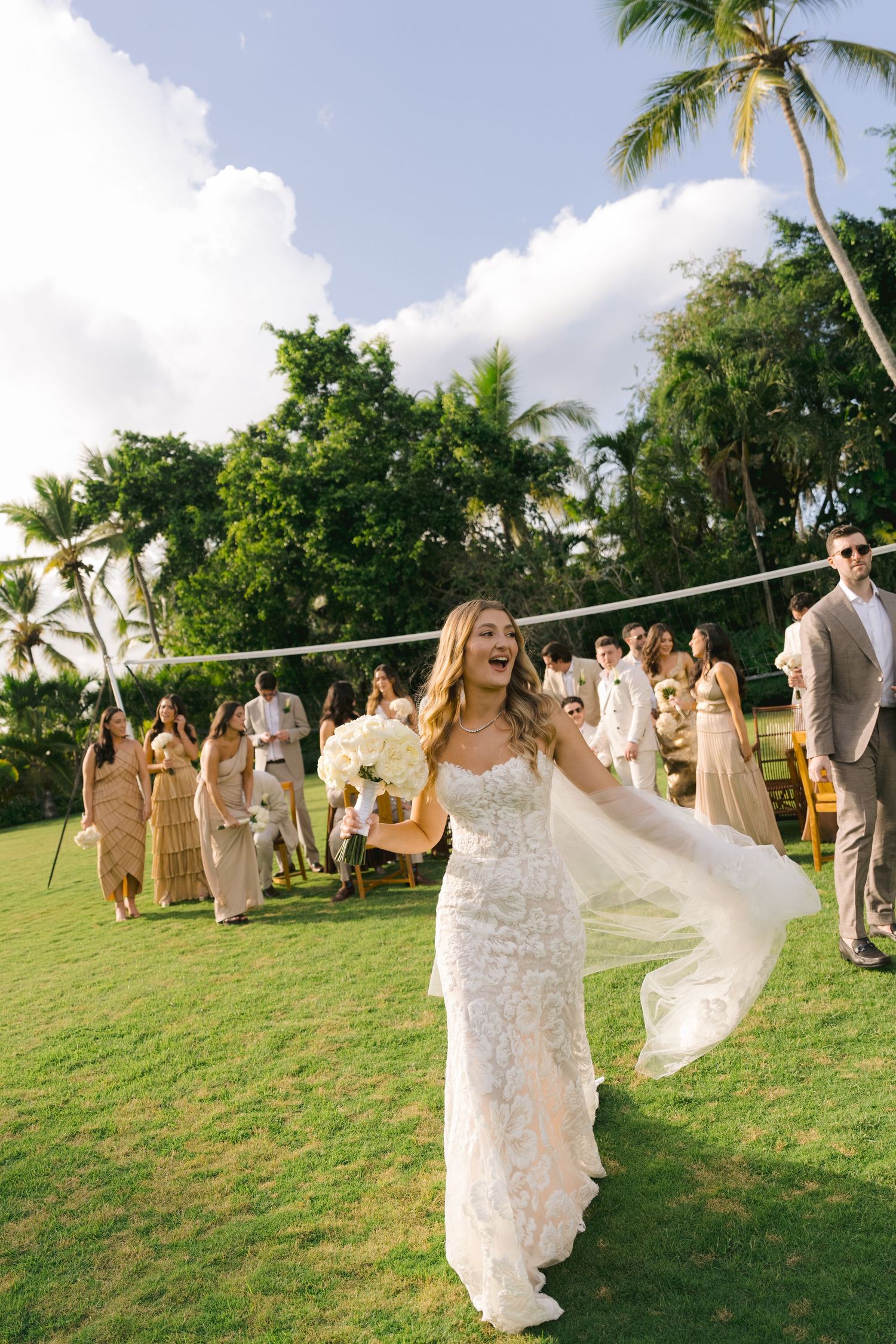 A sequence of wedding celebration photos showing dancing and festivities on a grassy lawn with palm trees in Hawaii.