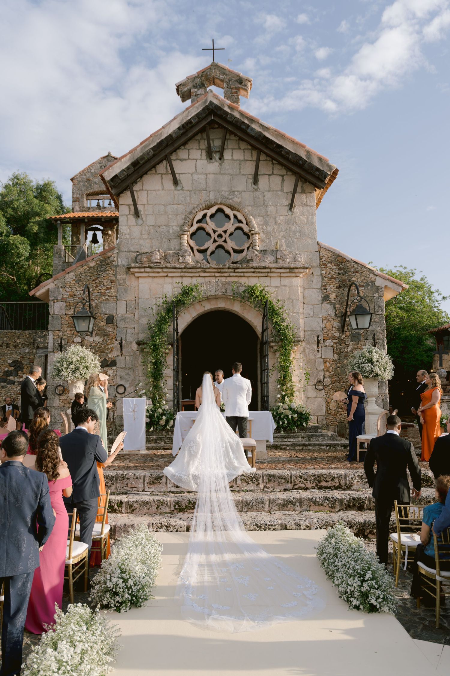 Beautiful stone chapel decorated with flowers for outdoor wedding ceremony.