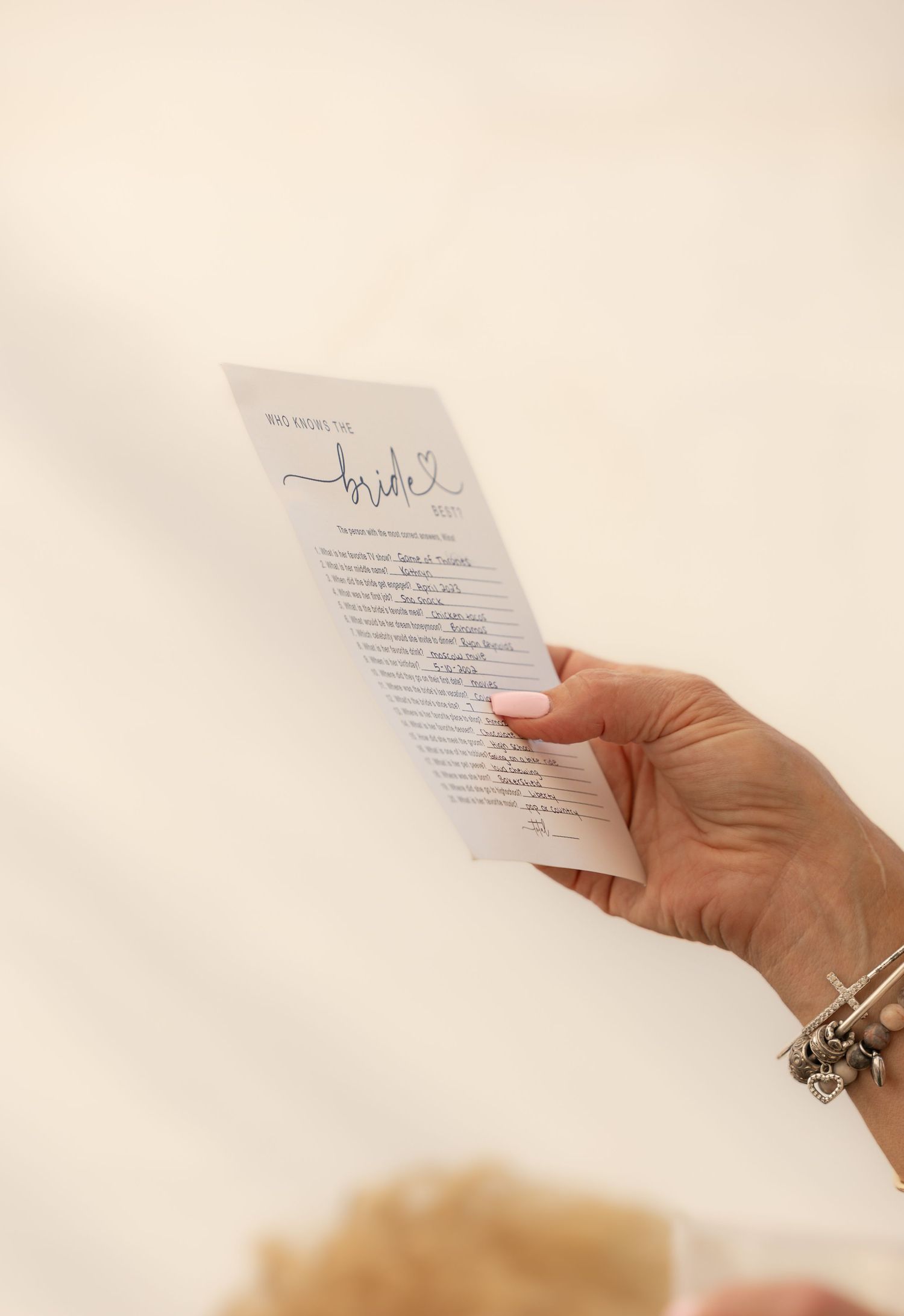 woman holding bridal shower game