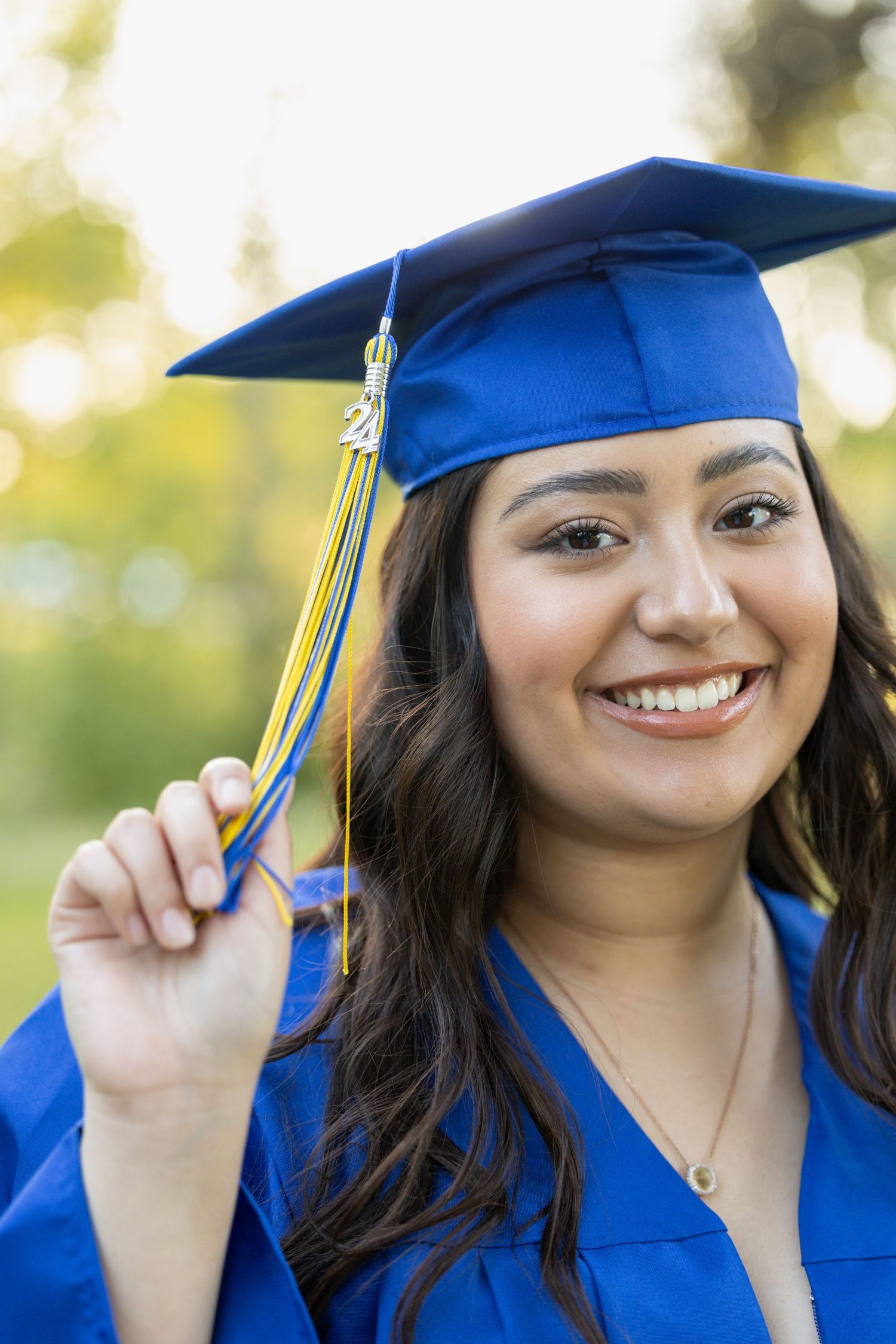 high school senior holding tassel on graduation cap