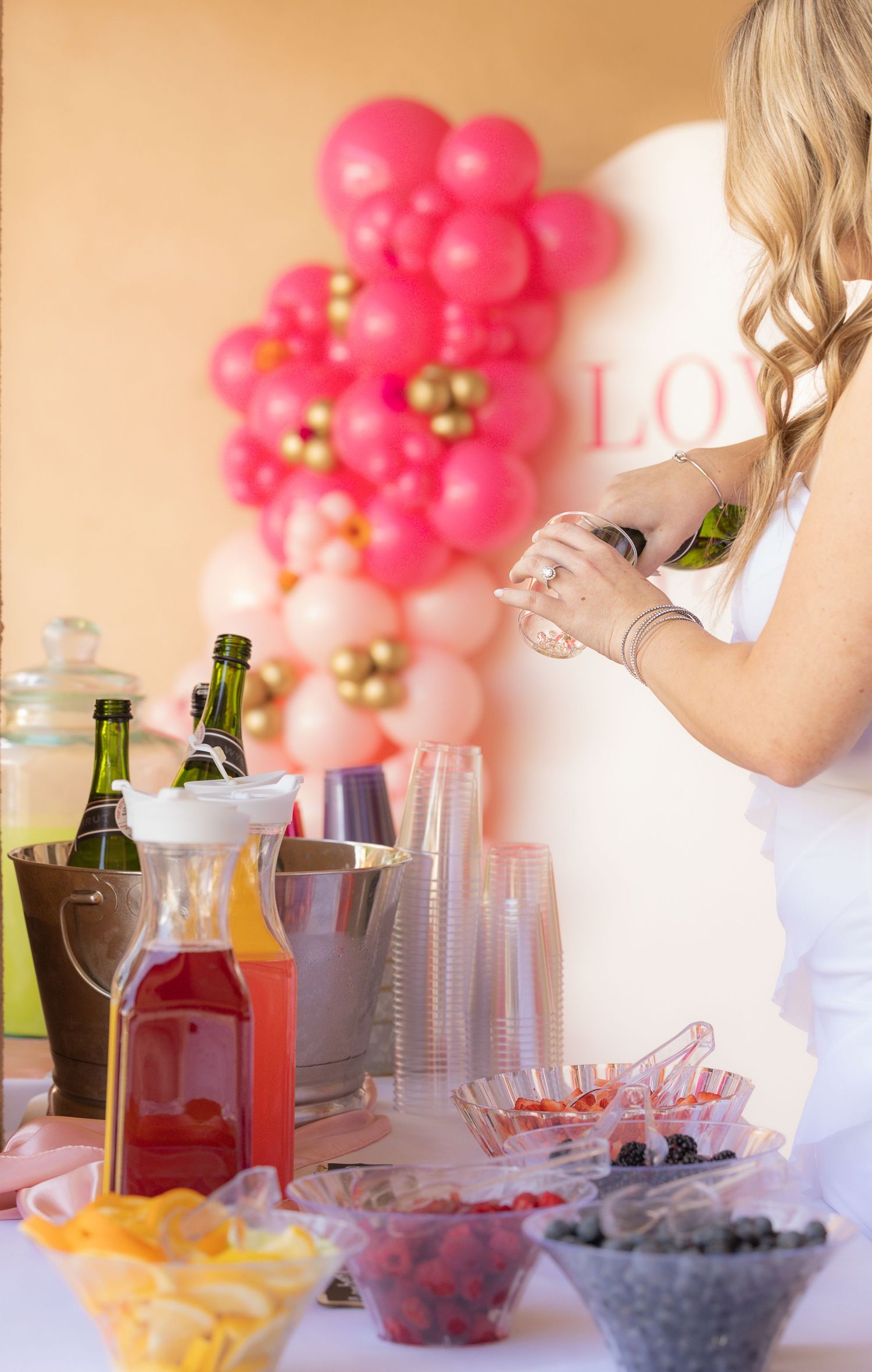 woman pouring champagne into cup
