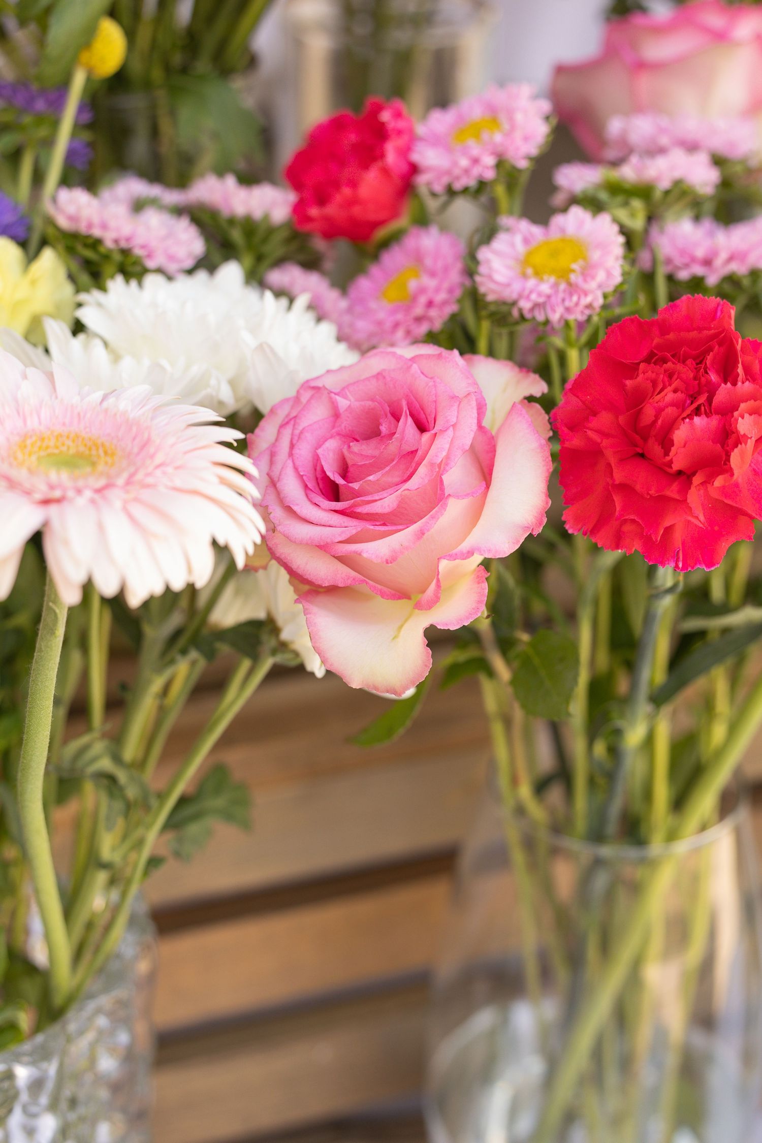 different colored flowers in vases