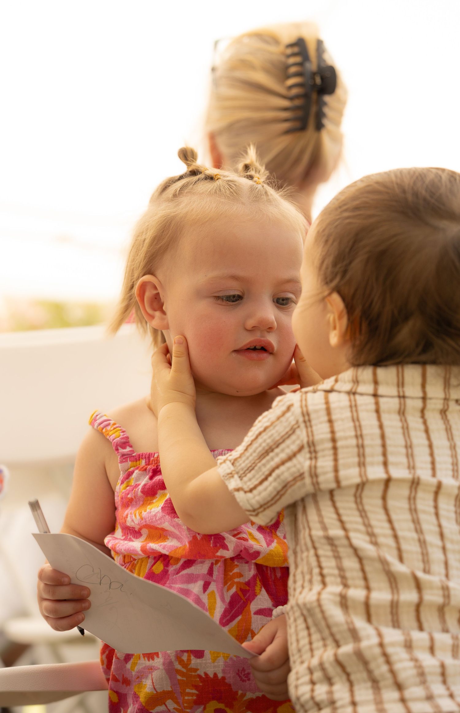 2 toddlers looking at each other