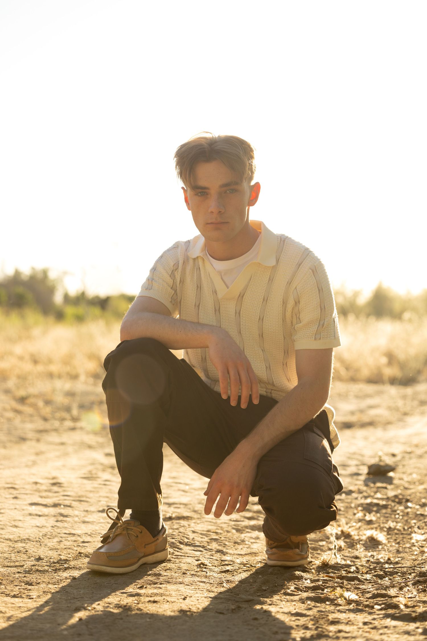 high school senior crouching down