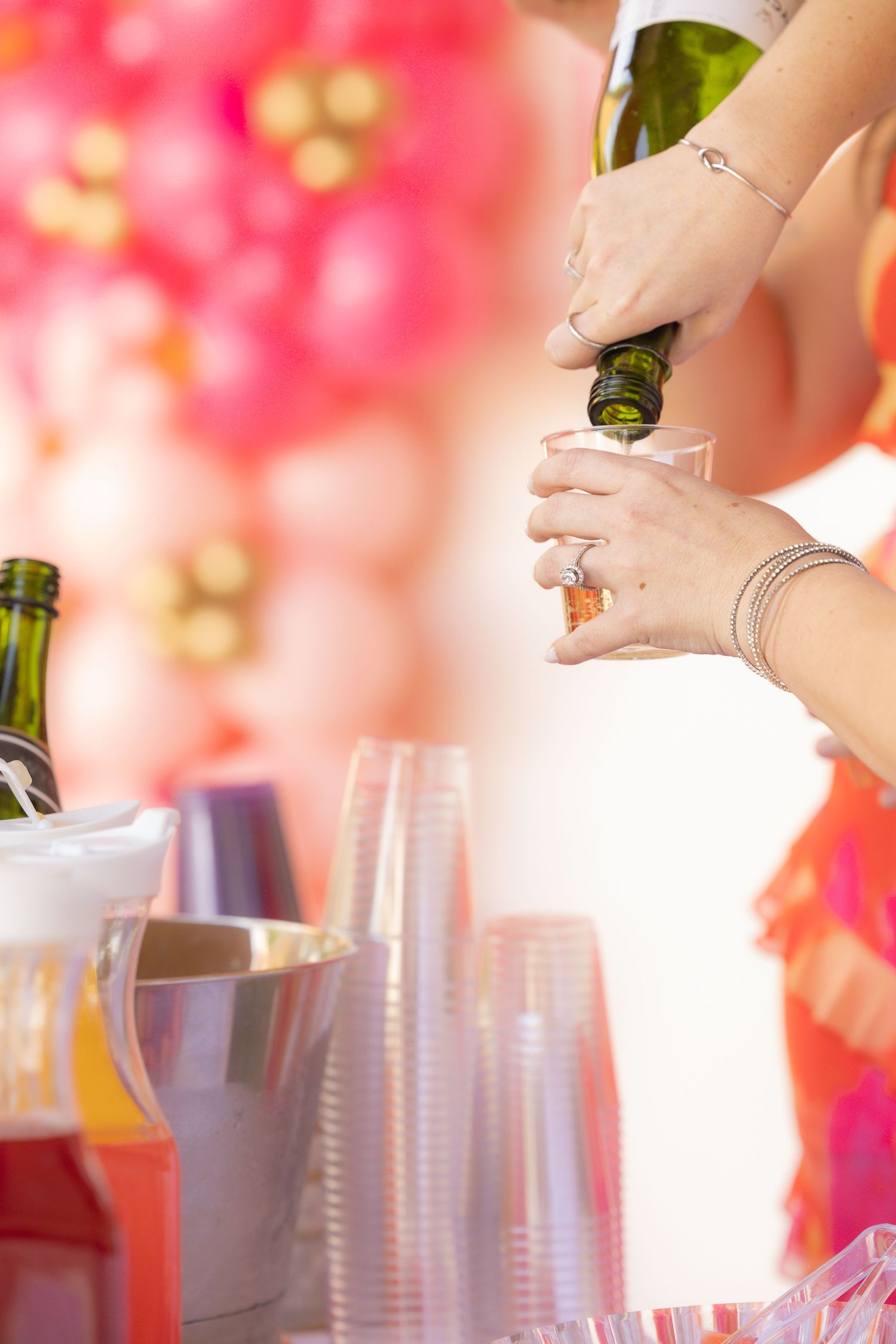 woman pouring champagne into cup