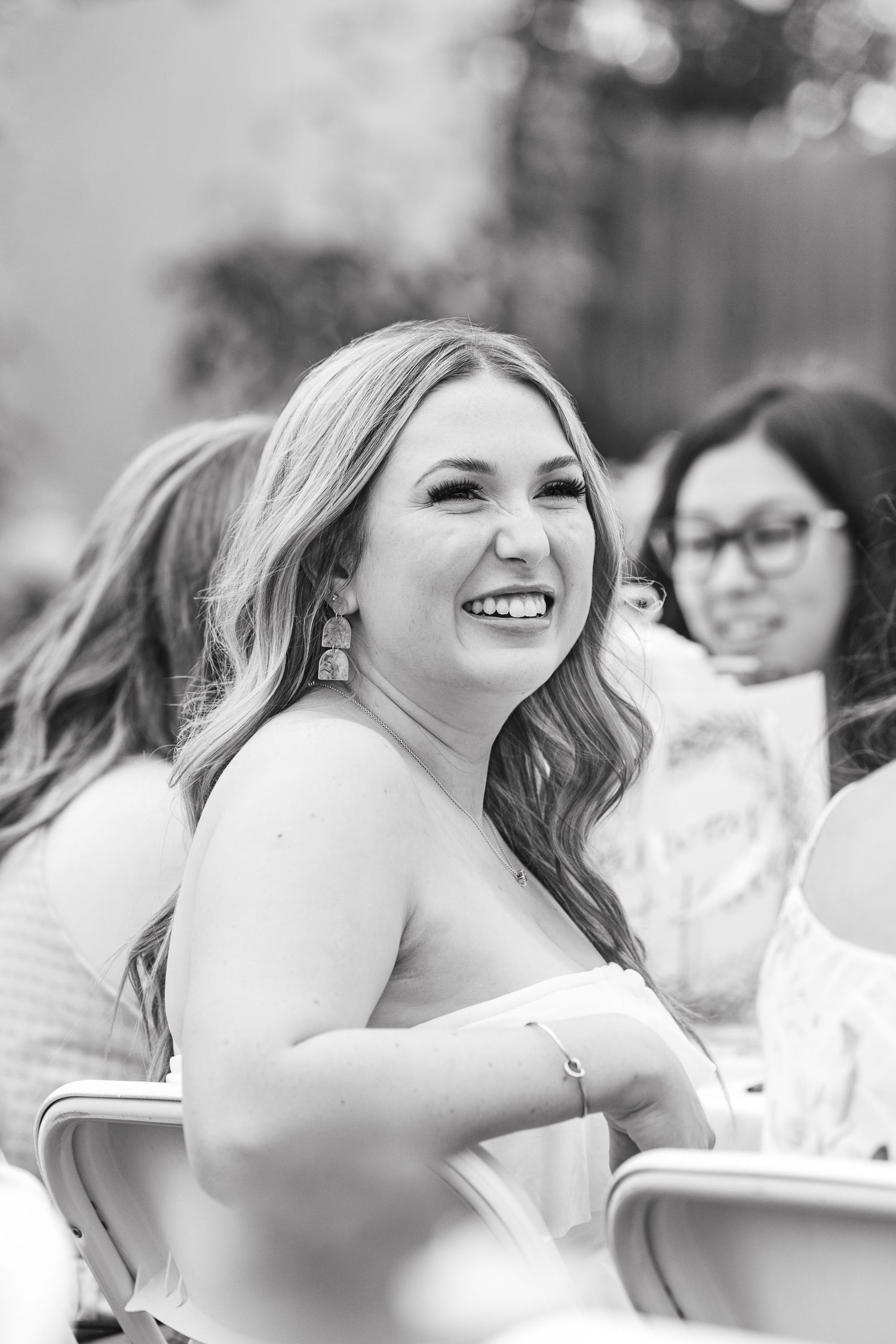 woman smiling over her shoulder in black and white