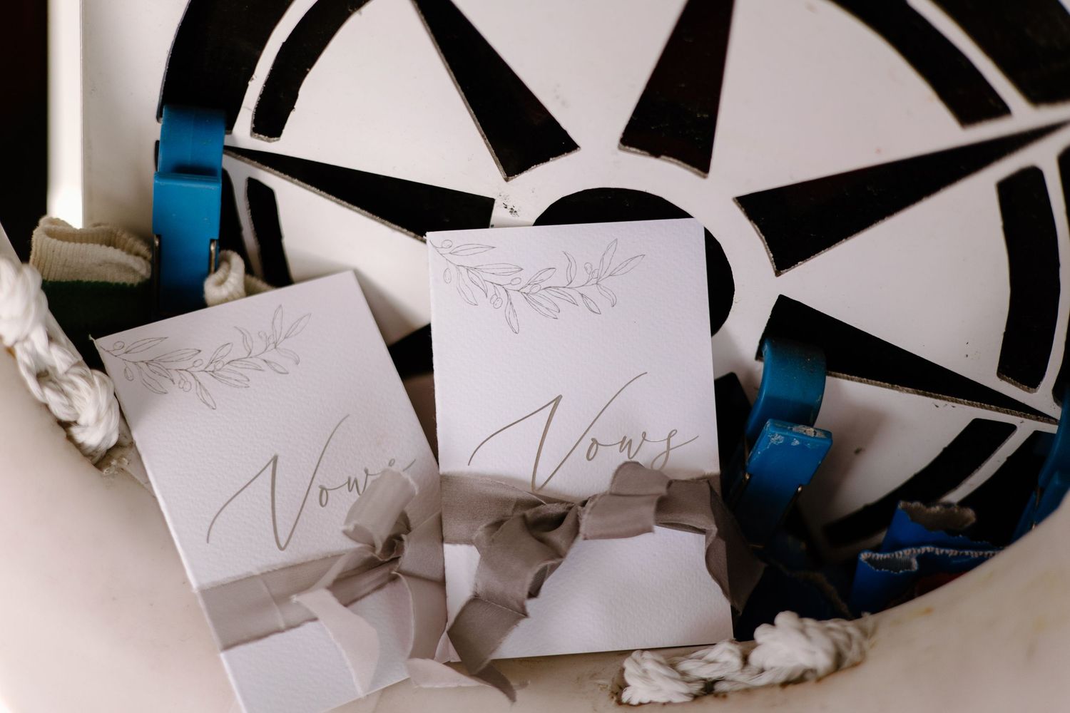 A series of handwritten notes or cards arranged in sequence on a black and white surface.