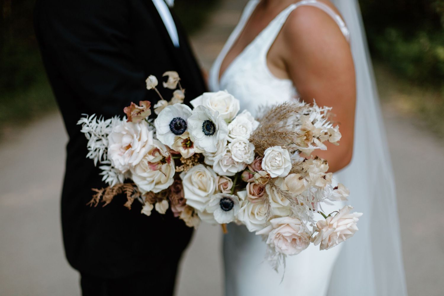 Elegant white wedding bouquet with roses and delicate floral arrangements.