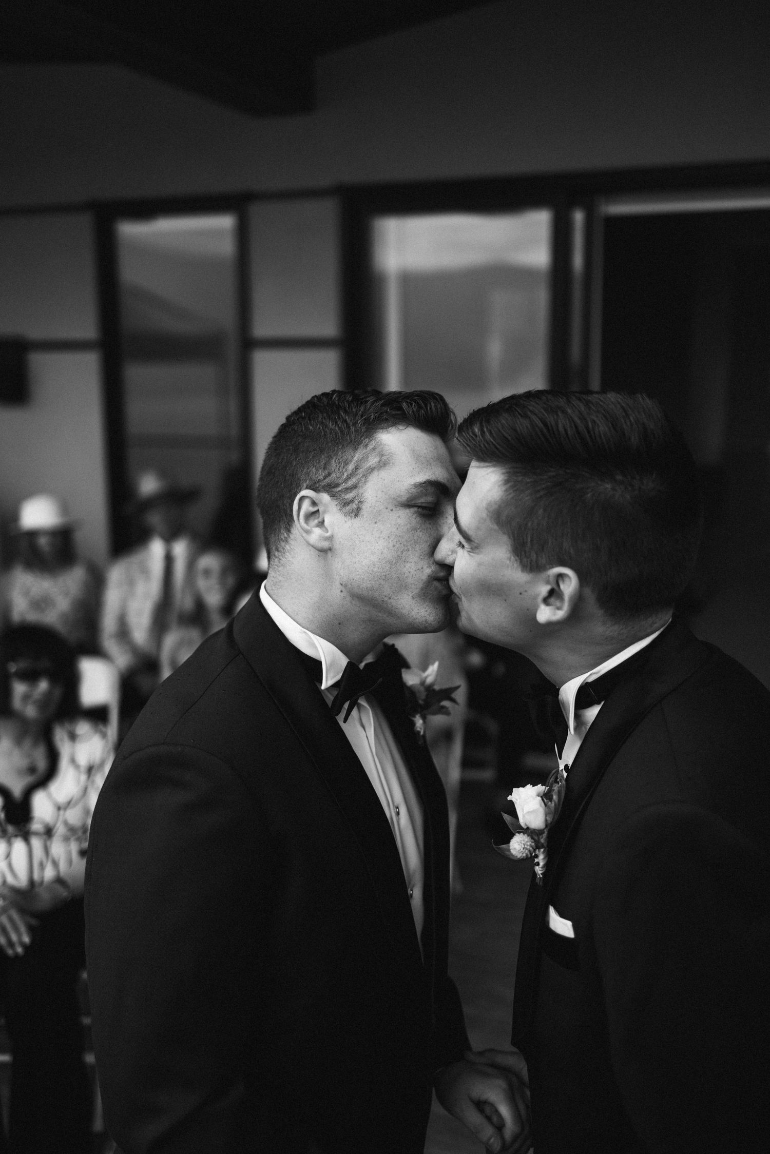 A romantic black and white moment captured during a formal wedding celebration.