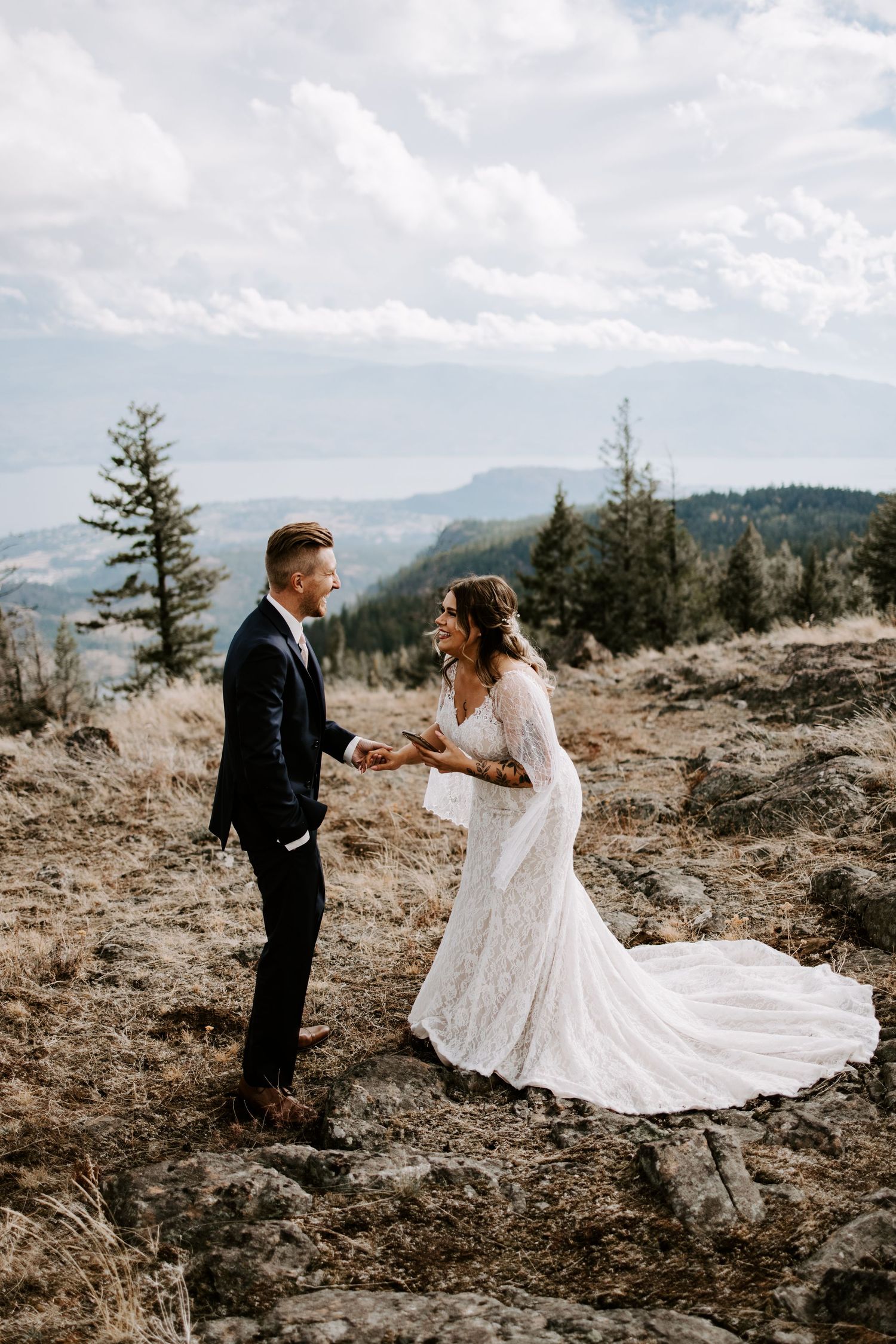 Mountain wedding ceremony with dramatic landscape and flowing white wedding dress.