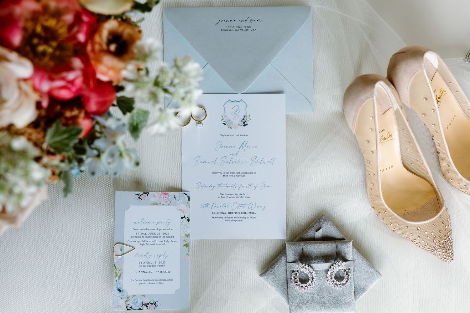 Wedding invitation suite and sparkly bridal shoes arranged with floral details.
