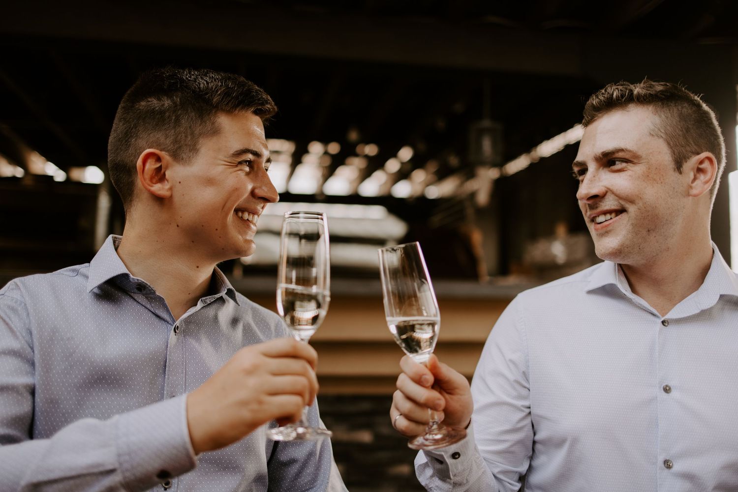 Two people toast with champagne glasses while sharing a joyful moment.