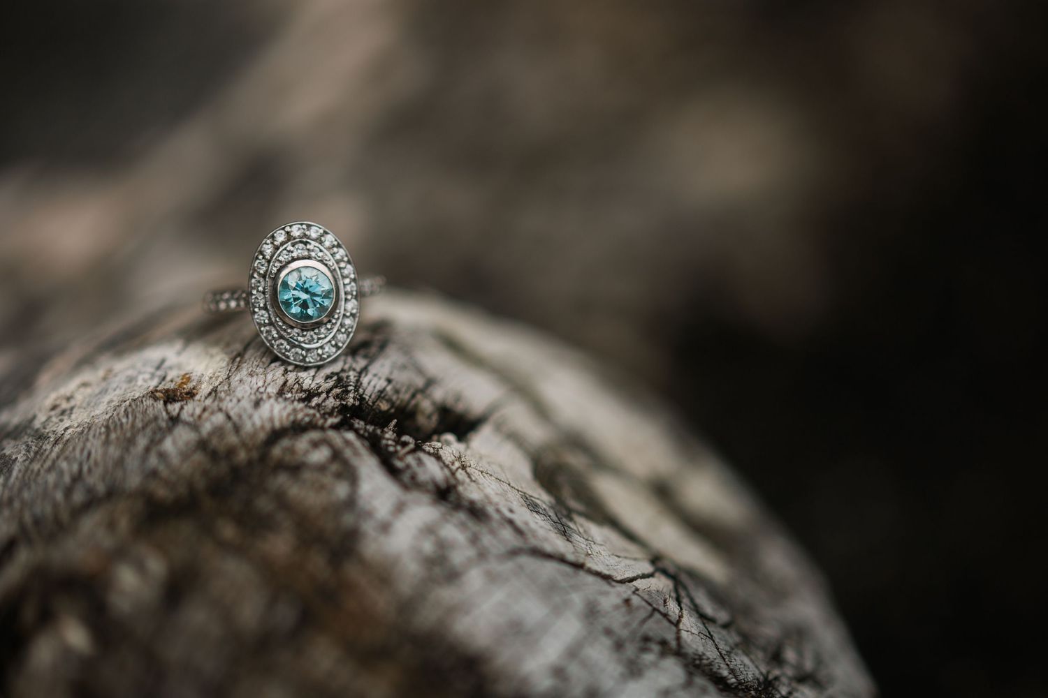 Close-up detail shots of engagement rings on natural stone texture.