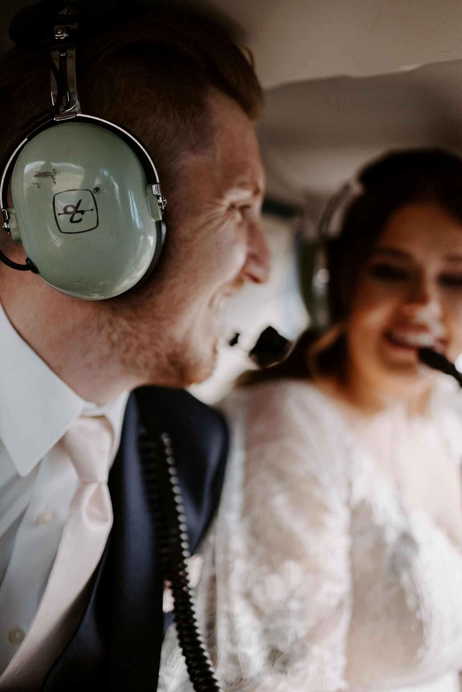 Headphones and formal attire details in a helicopter interior during a special event.