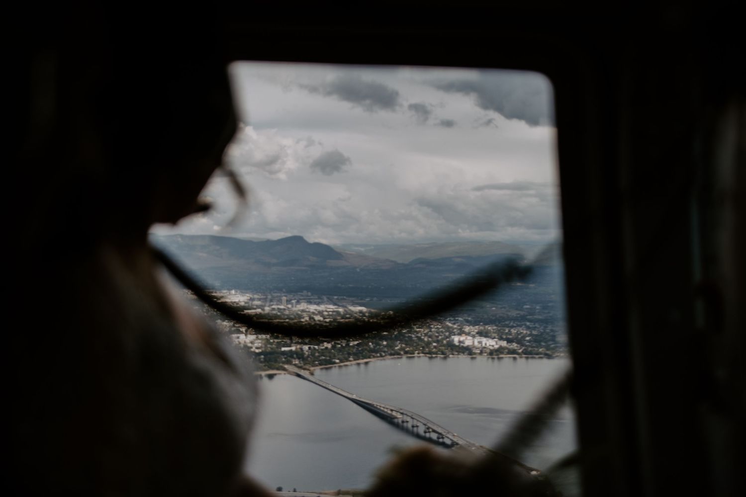 A scenic mountain landscape viewed through an aircraft window.