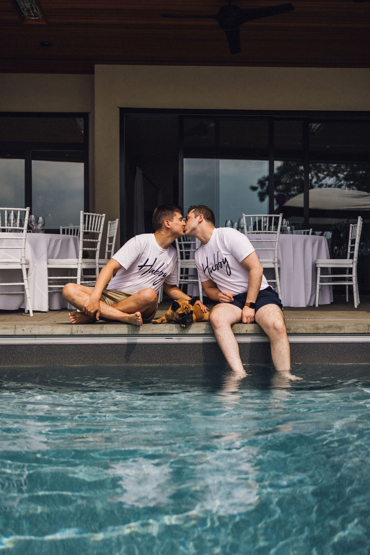 A romantic couple sits by a swimming pool with their feet in the turquoise water, shown in multiple progressive shots.