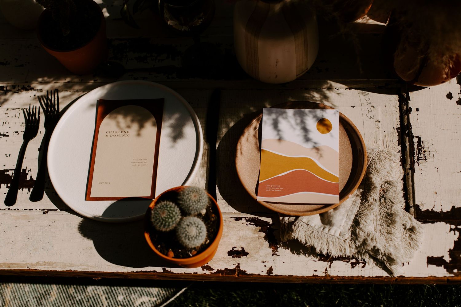Wedding place setting with minimalist desert-themed menu card.