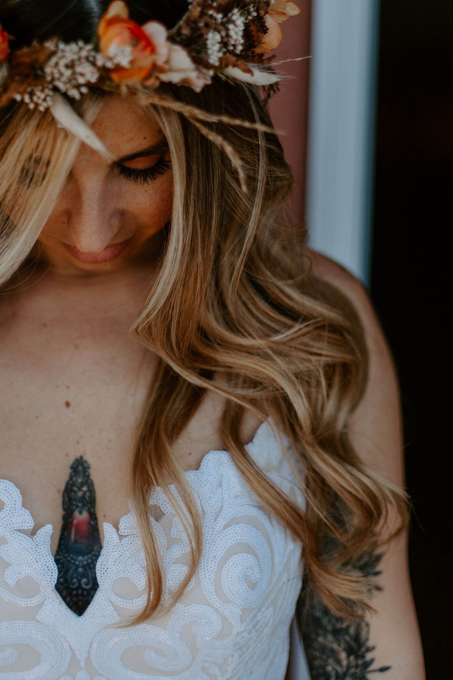 Wedding look featuring floral crown and detailed white dress bodice.