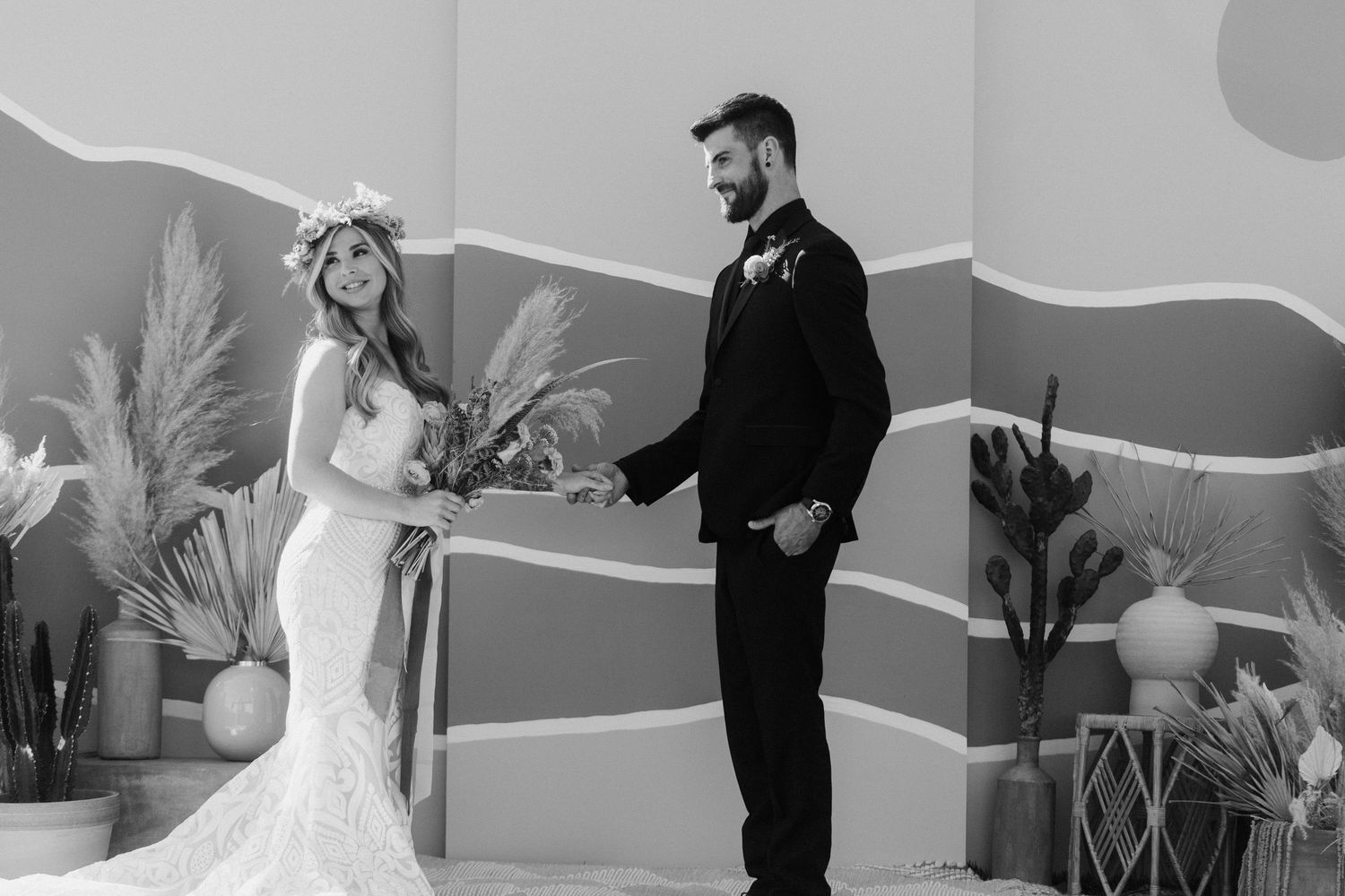 Black and white wedding moment captured against geometric wall design.