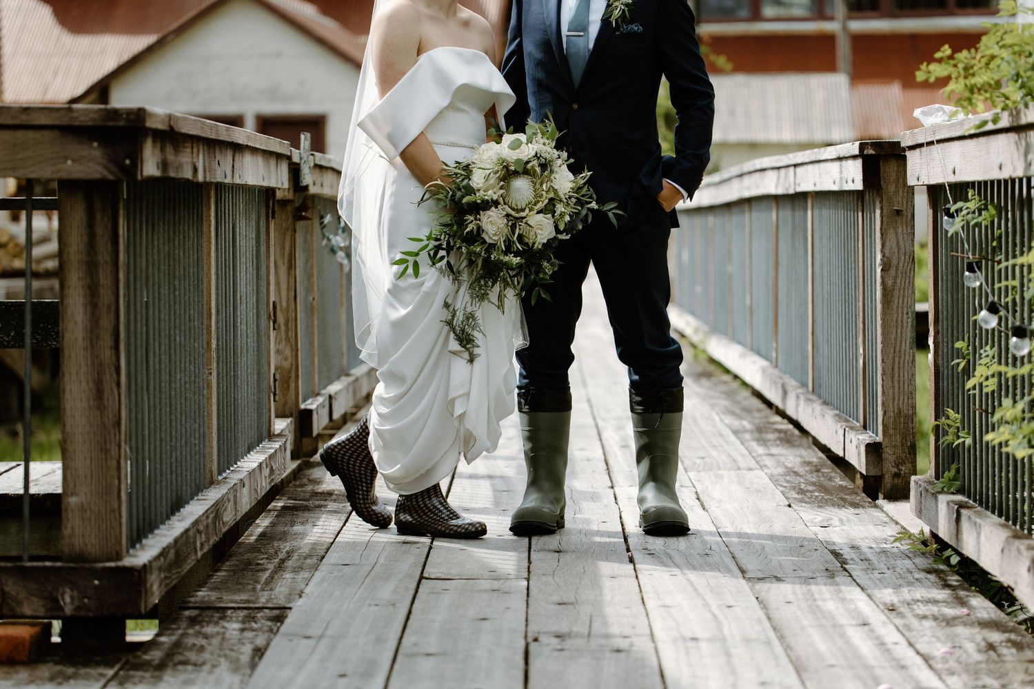 Formal dress shoes walking on wooden boardwalk surface.