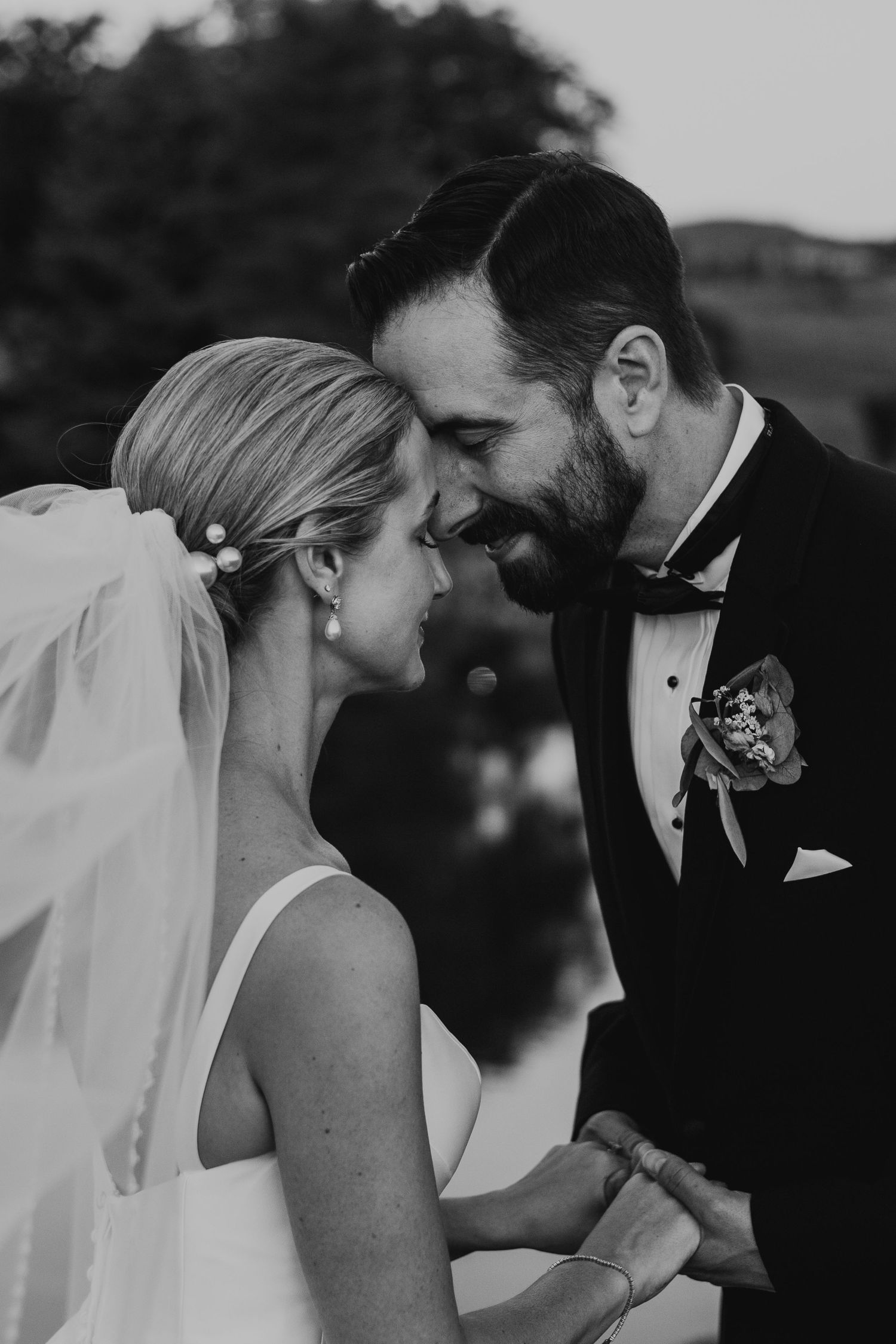 A series of romantic black and white wedding photos showing tender moments between newlyweds.