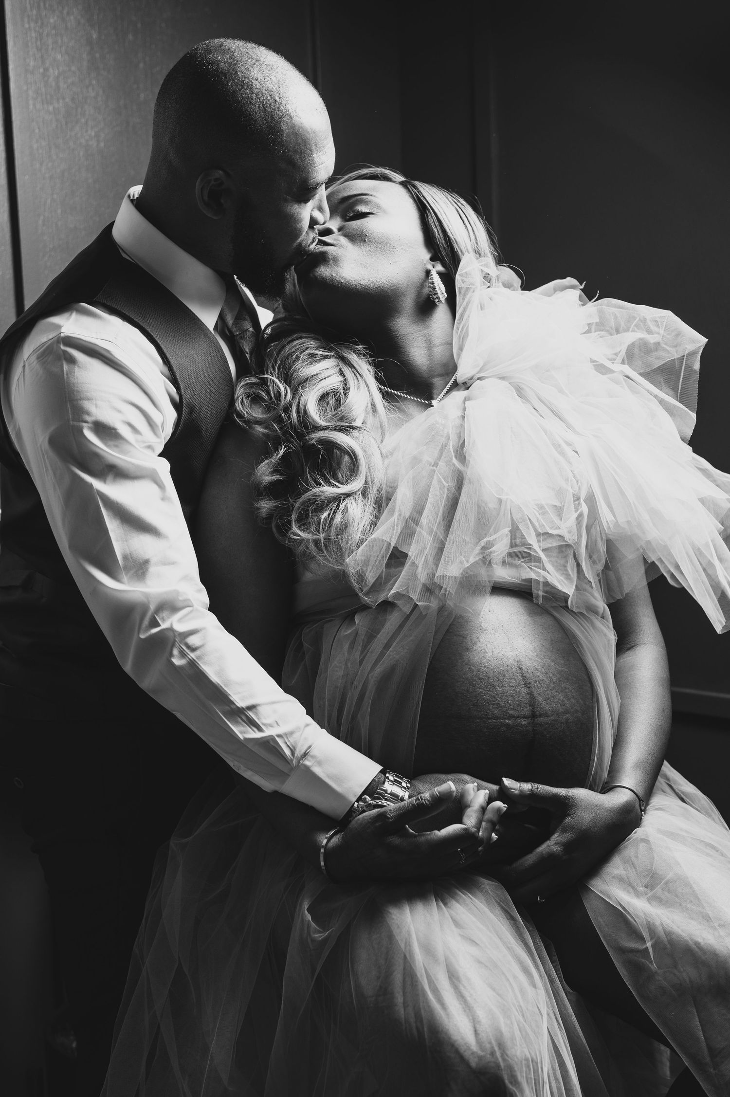 A romantic black and white photo series showing intimate moments between a couple in wedding attire.