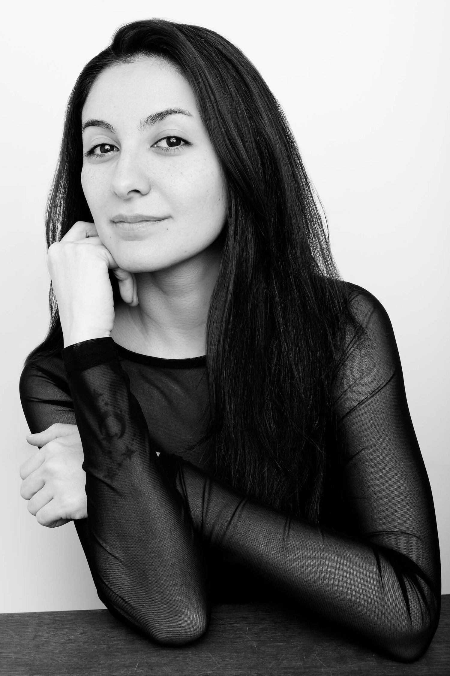 Black and white studio portraits showing expressive poses in sheer black clothing.